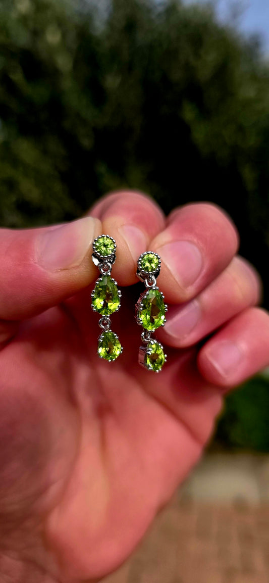 Fresh, vibrant, and full of graceful movement... these elegant sterling silver drop earrings celebrate the captivating beauty of natural peridot.