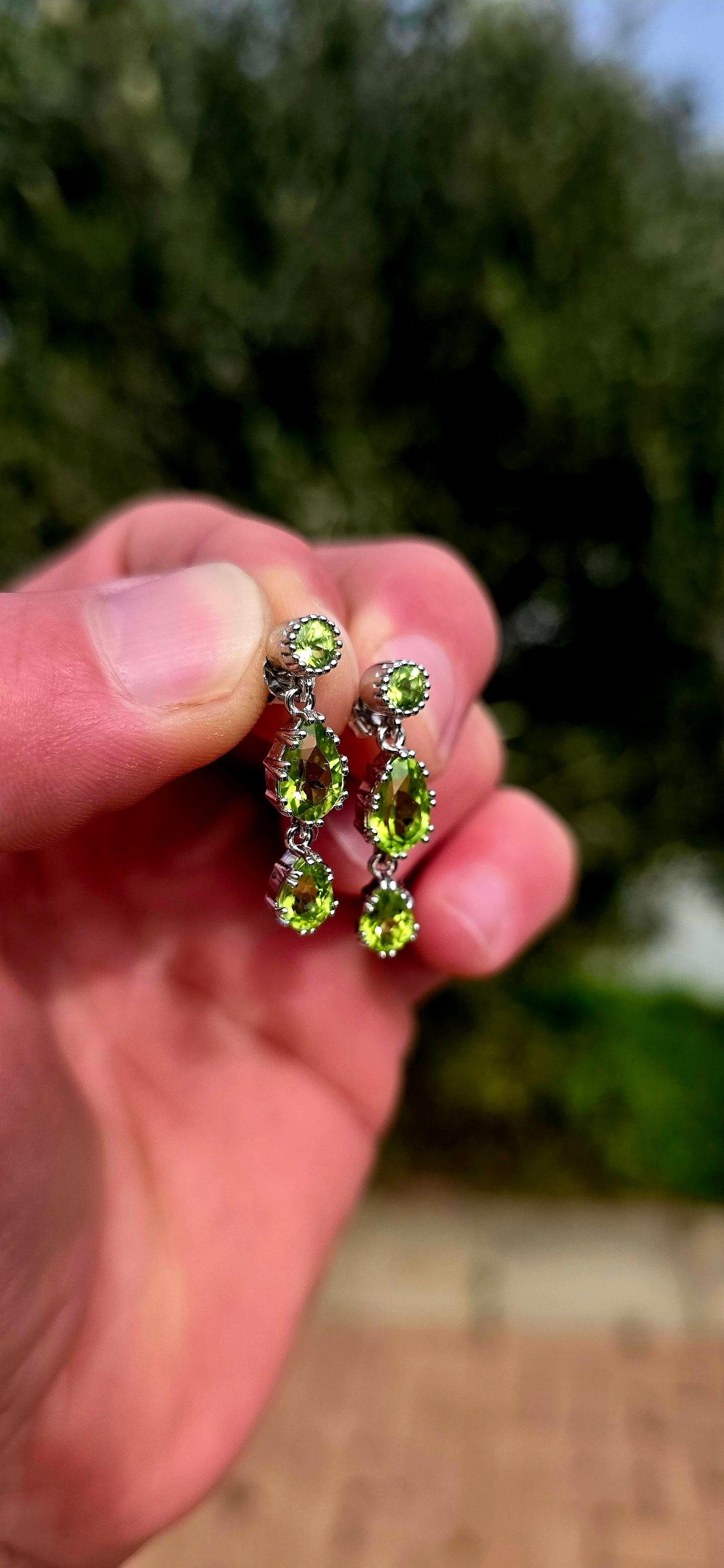 Fresh, vibrant, and full of graceful movement... these elegant sterling silver drop earrings celebrate the captivating beauty of natural peridot.