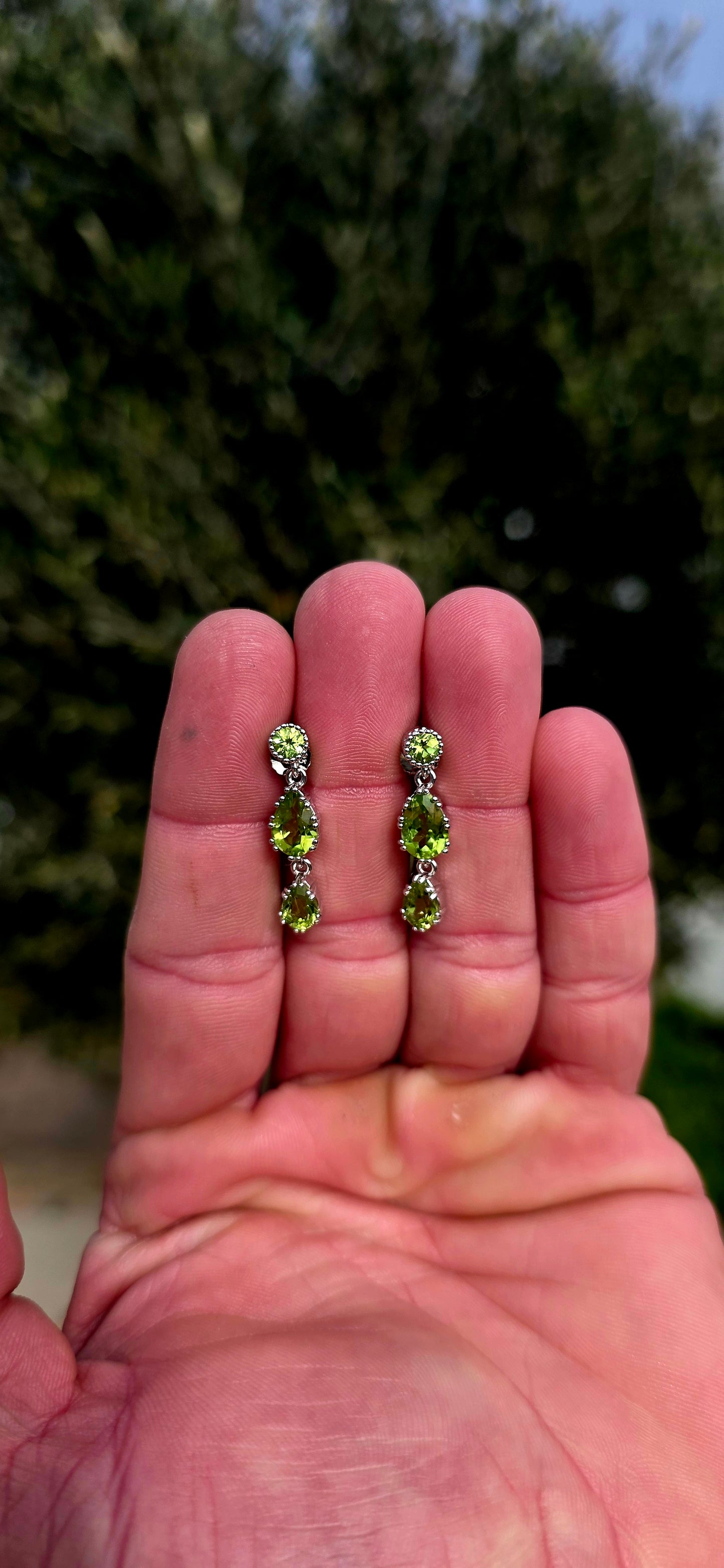 Fresh, vibrant, and full of graceful movement... these elegant sterling silver drop earrings celebrate the captivating beauty of natural peridot.
