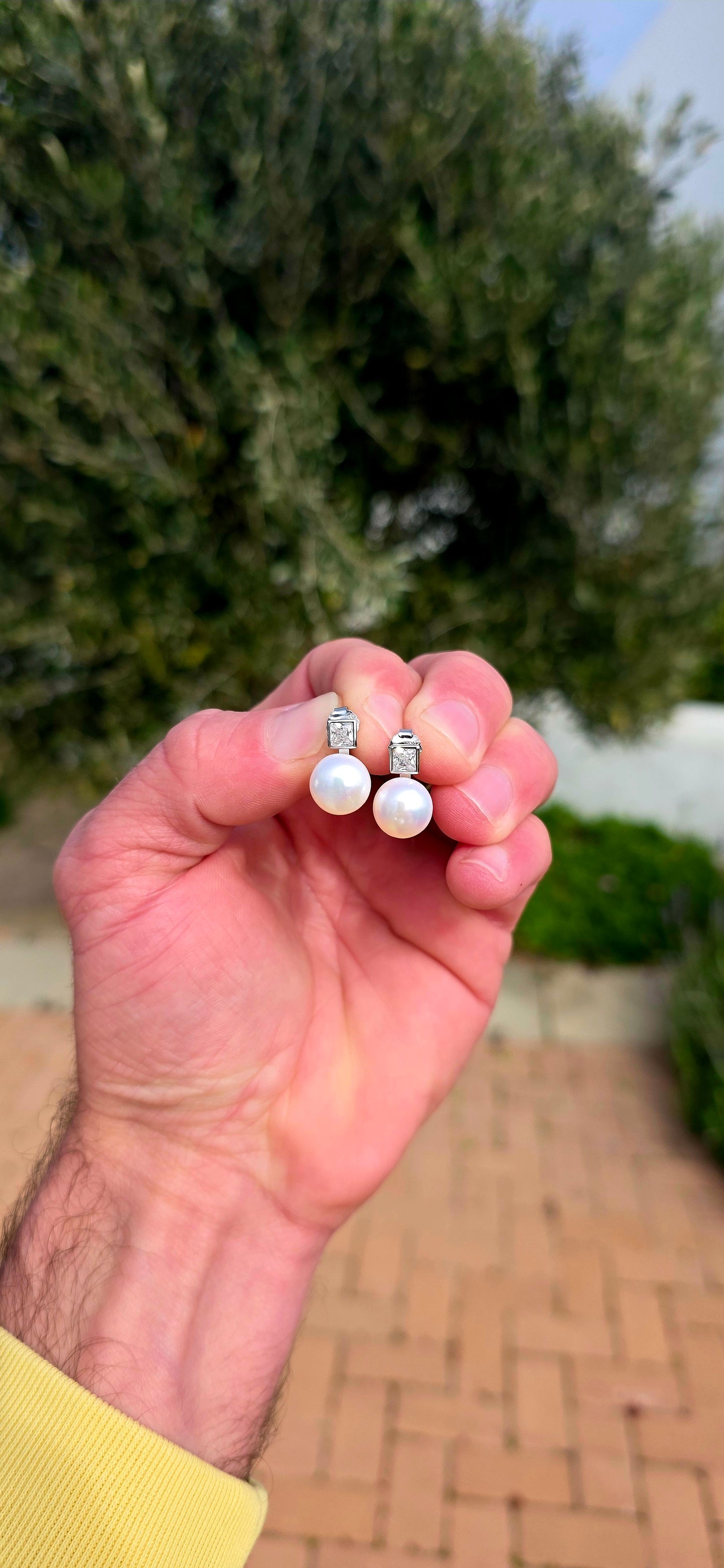 Classic, elegant and forever in style... these beautiful sterling silver stud earrings combine the beauty of pearls with the captivating sparkle of brilliant cubic zirconia.