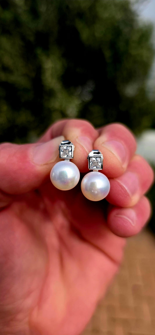 Classic, elegant and forever in style... these beautiful sterling silver stud earrings combine the beauty of pearls with the captivating sparkle of brilliant cubic zirconia.