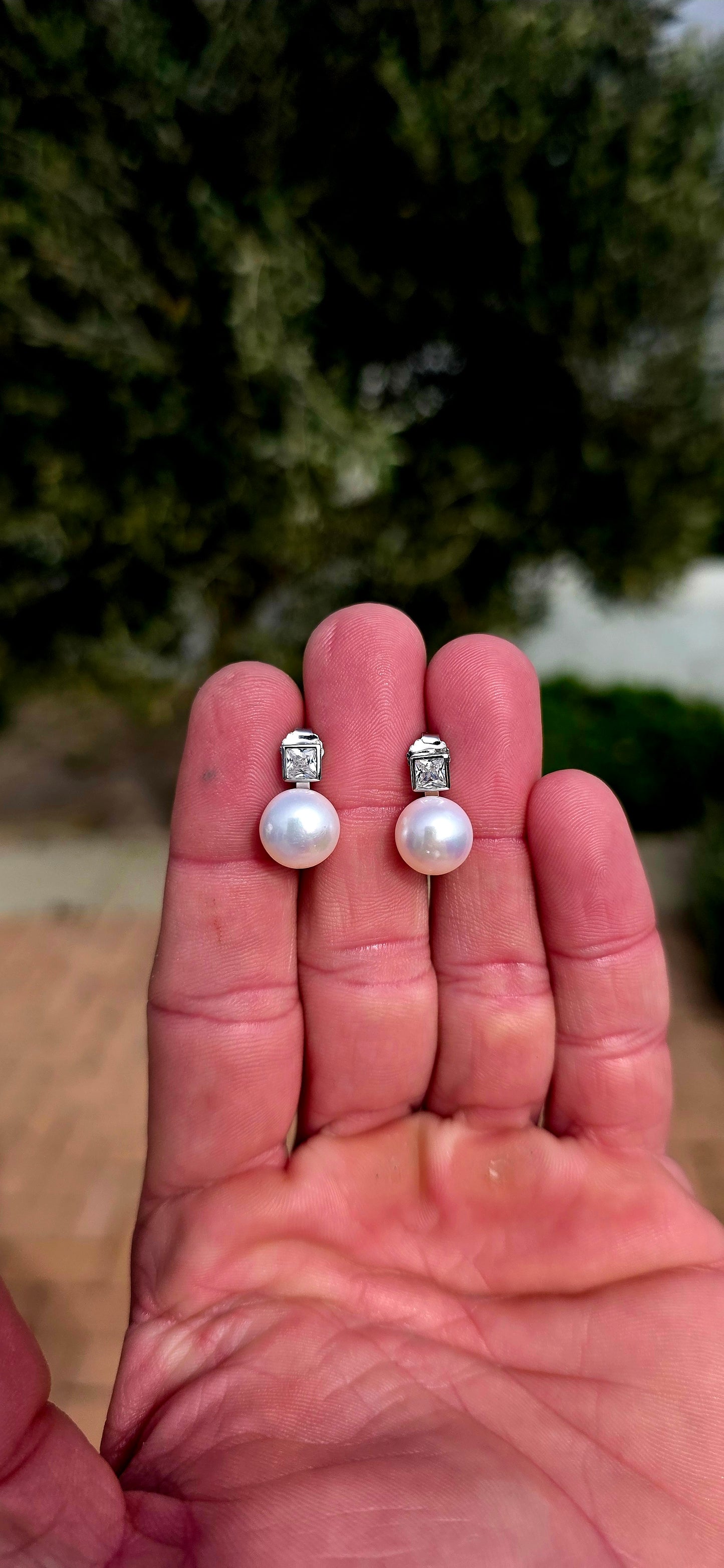 Classic, elegant and forever in style... these beautiful sterling silver stud earrings combine the beauty of pearls with the captivating sparkle of brilliant cubic zirconia.