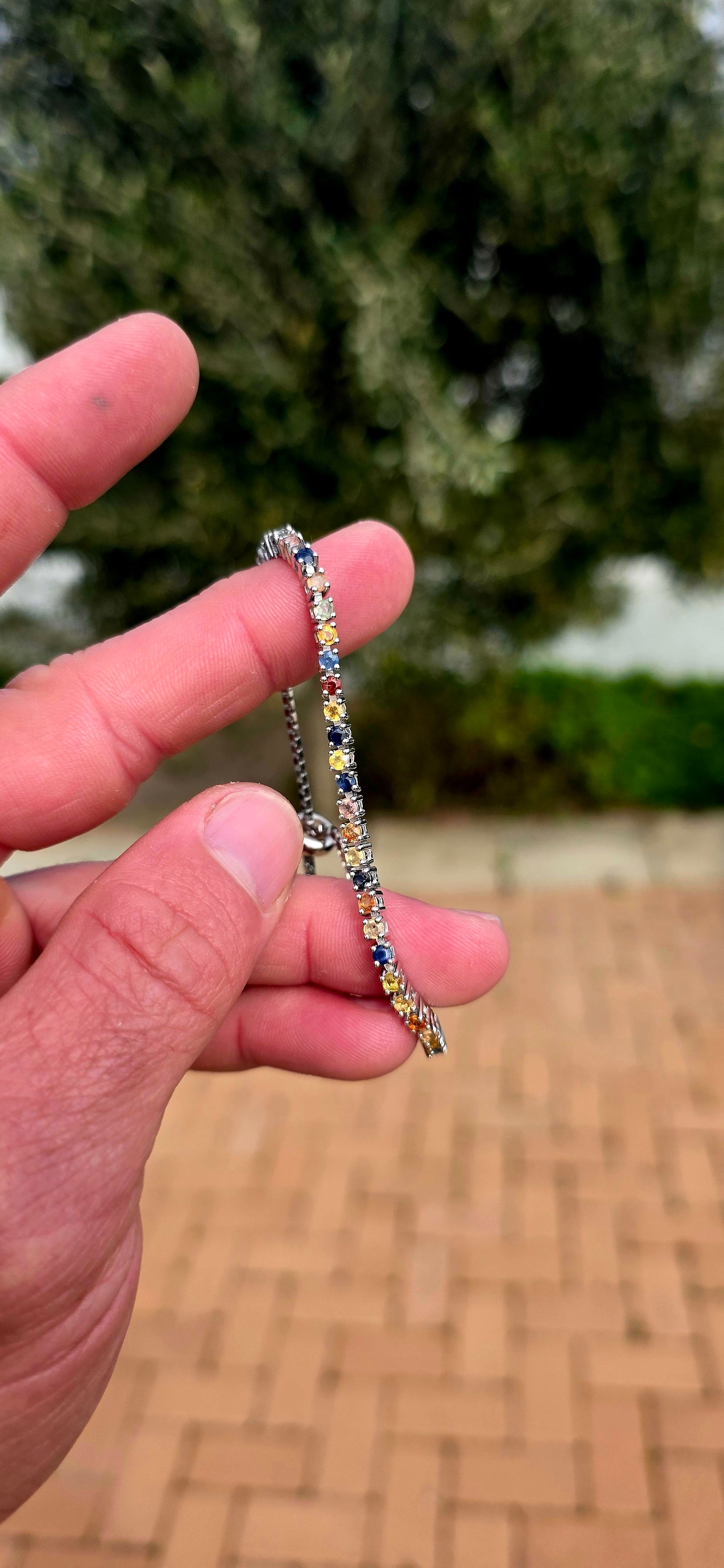 Vibrant ans elegant ... this beautiful unisex sterling silver tennis bracelet is a celebration of colour, featuring a dazzling spectrum of natural sapphires.