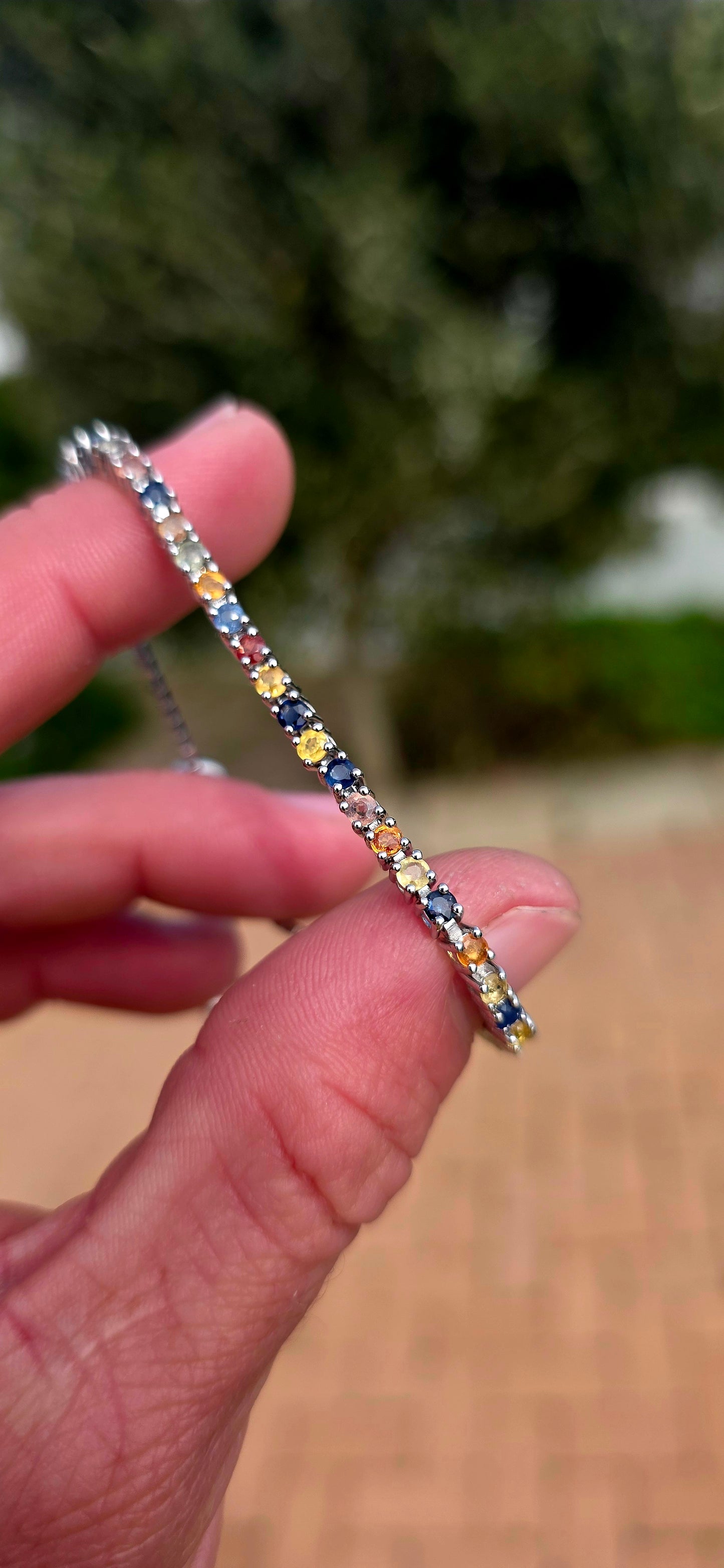 Vibrant ans elegant ... this beautiful unisex sterling silver tennis bracelet is a celebration of colour, featuring a dazzling spectrum of natural sapphires.