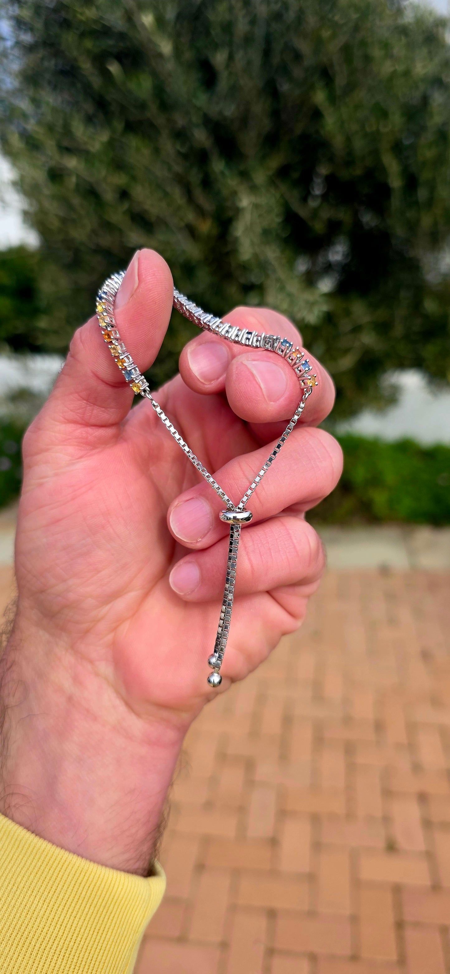 Vibrant ans elegant ... this beautiful unisex sterling silver tennis bracelet is a celebration of colour, featuring a dazzling spectrum of natural sapphires.