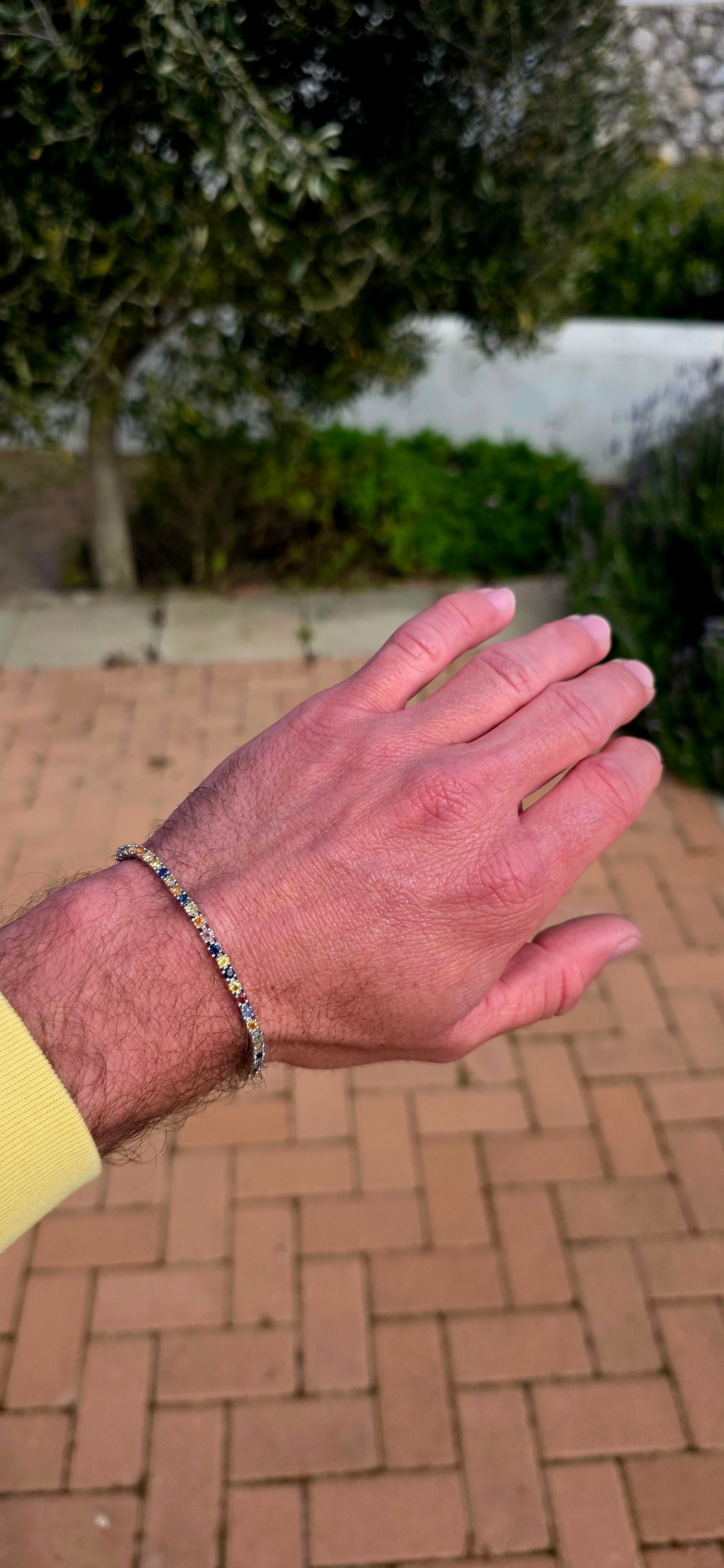Vibrant ans elegant ... this beautiful unisex sterling silver tennis bracelet is a celebration of colour, featuring a dazzling spectrum of natural sapphires.