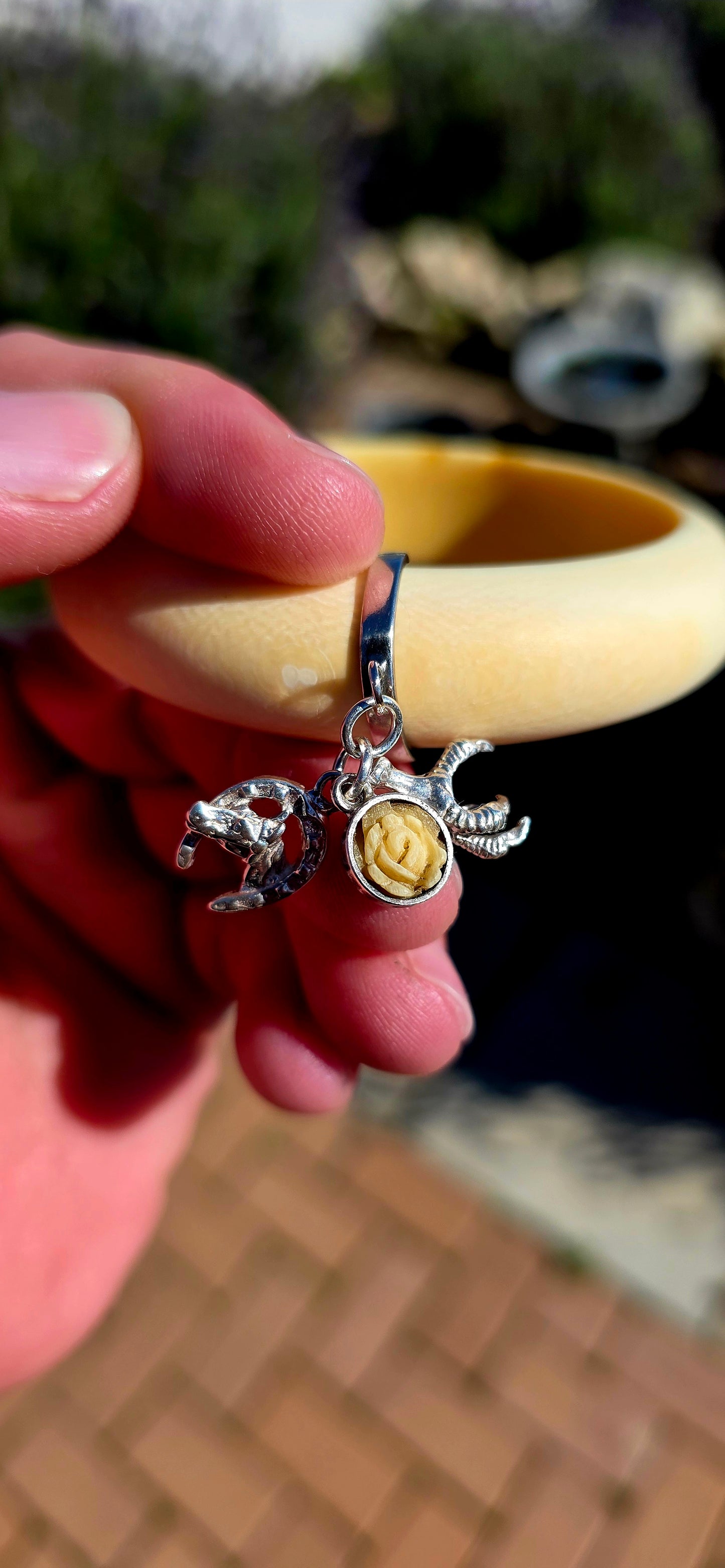 Wonderfully unique, beautifully symbolic, and rich in vintage character... this vintage pre-ban ivory bangle is a delightful piece of wearable history, bringing together craftsmanship with meaningful lucky charms.