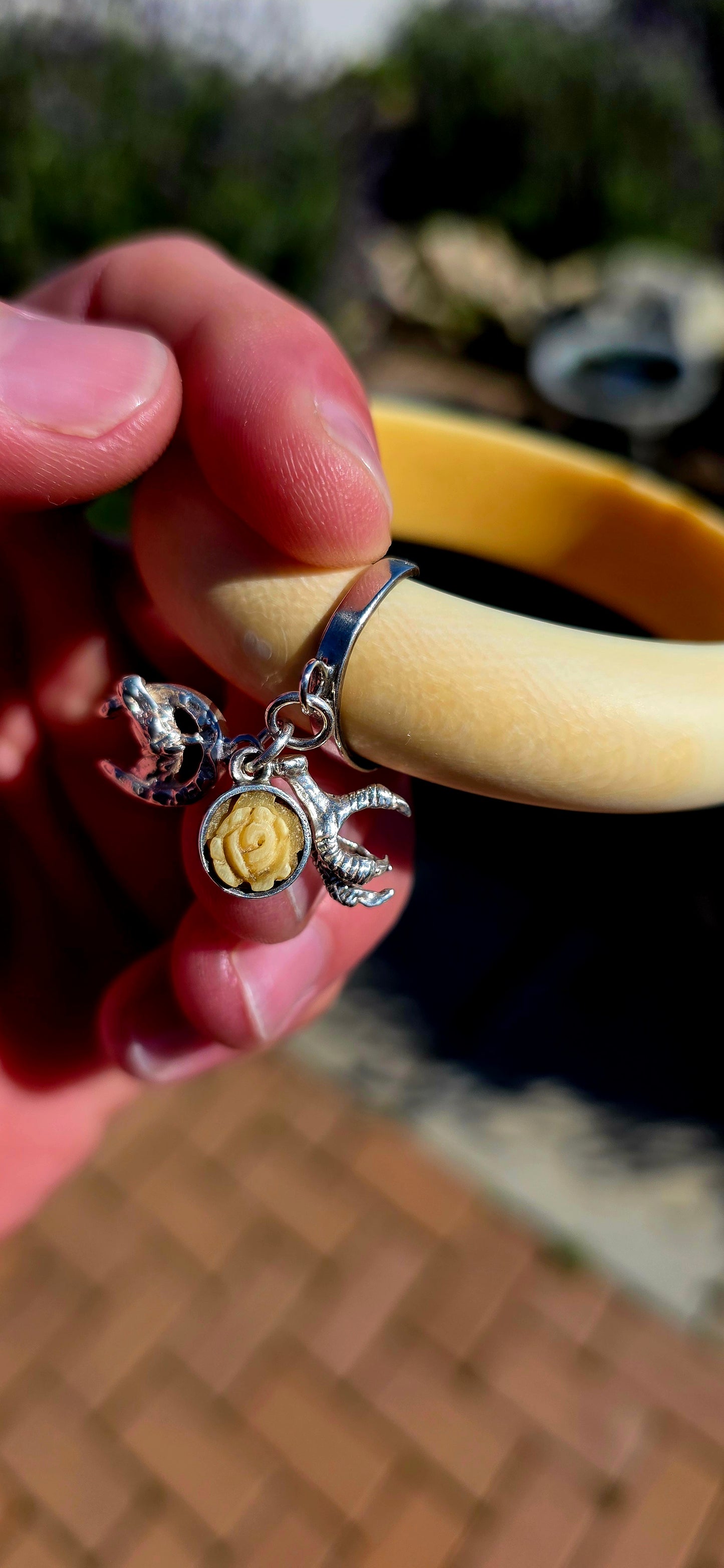 Wonderfully unique, beautifully symbolic, and rich in vintage character... this vintage pre-ban ivory bangle is a delightful piece of wearable history, bringing together craftsmanship with meaningful lucky charms.