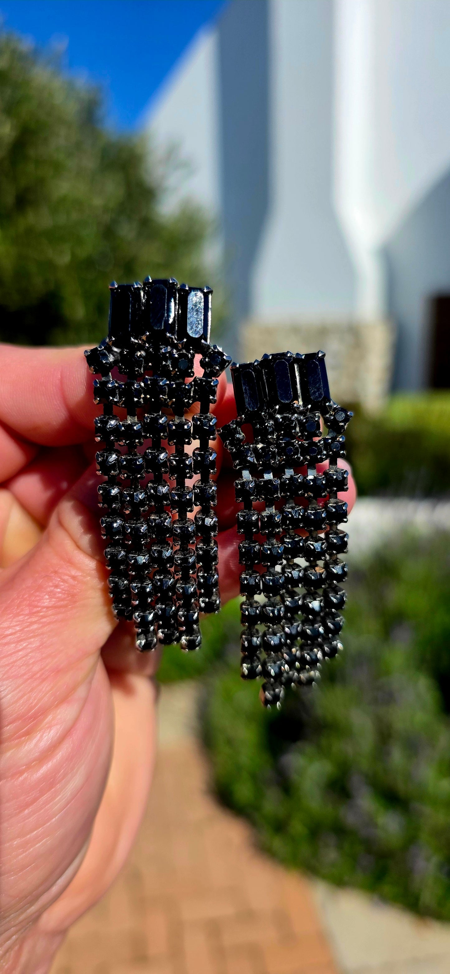 Dramatic, glamorous and wonderfully elegant... this striking pair of vintage Art Deco Revival waterfall clip-on earrings captures the sophistication of the Jazz Age with a bold monochromatic twist.