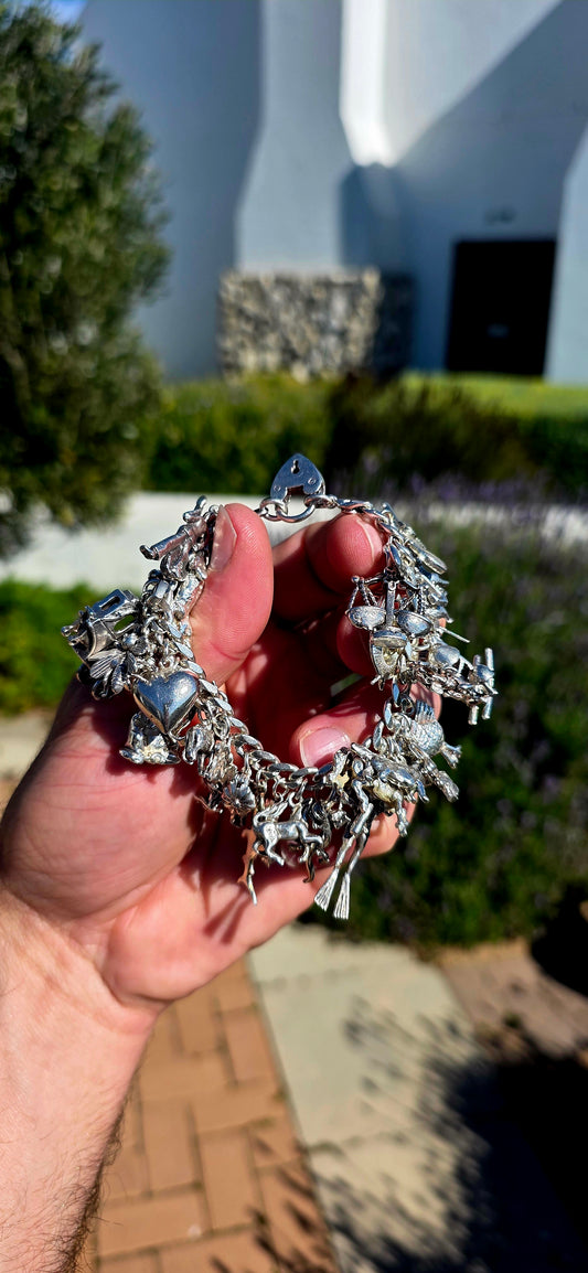 WOW... where do we even begin?  This is not just a bracelet... it's an extraordinary vintage treasure bursting with personality, history, and nostalgia.