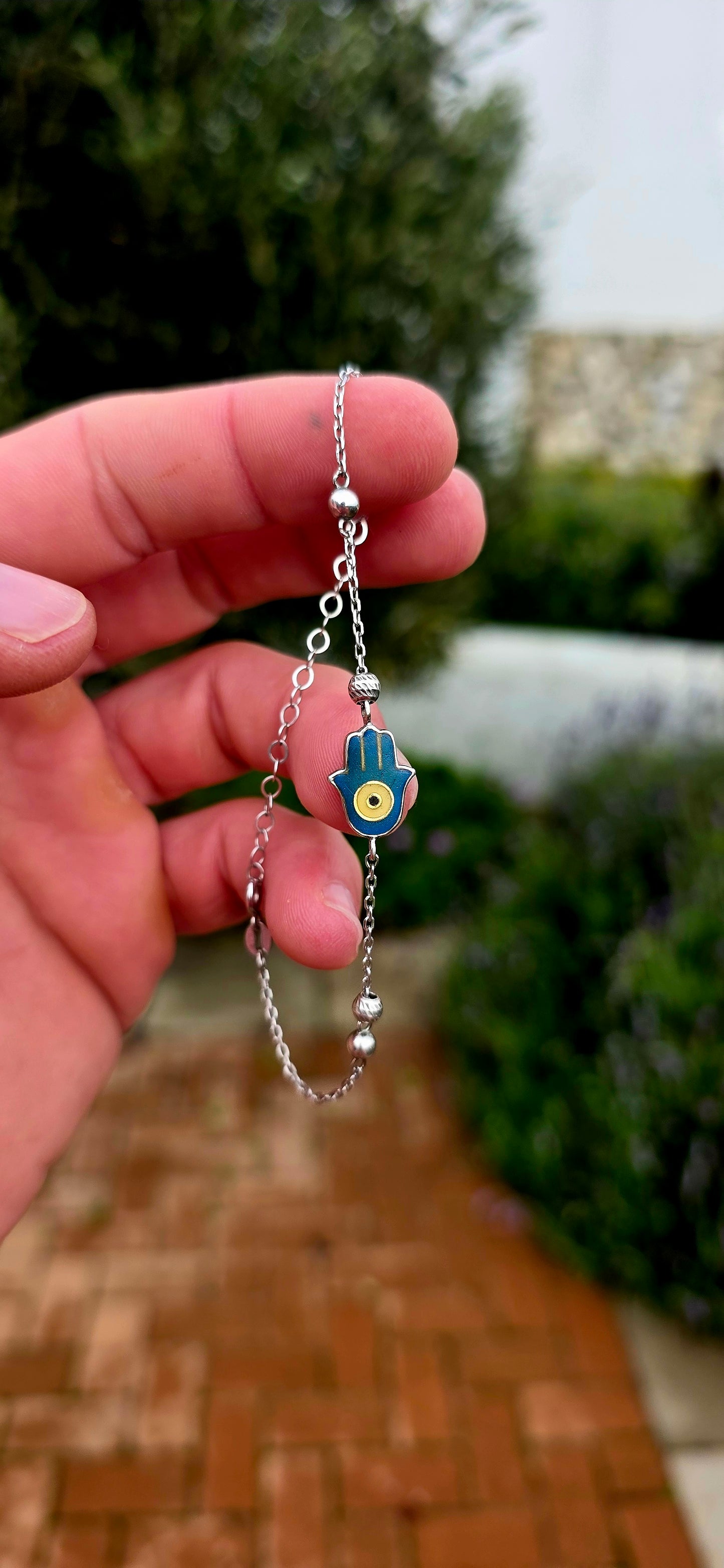Delicate, meaningful and stylish... this beautiful sterling silver bracelet is centred around one of the world's oldest and most cherished protective symbols — the Hamsa Hand.