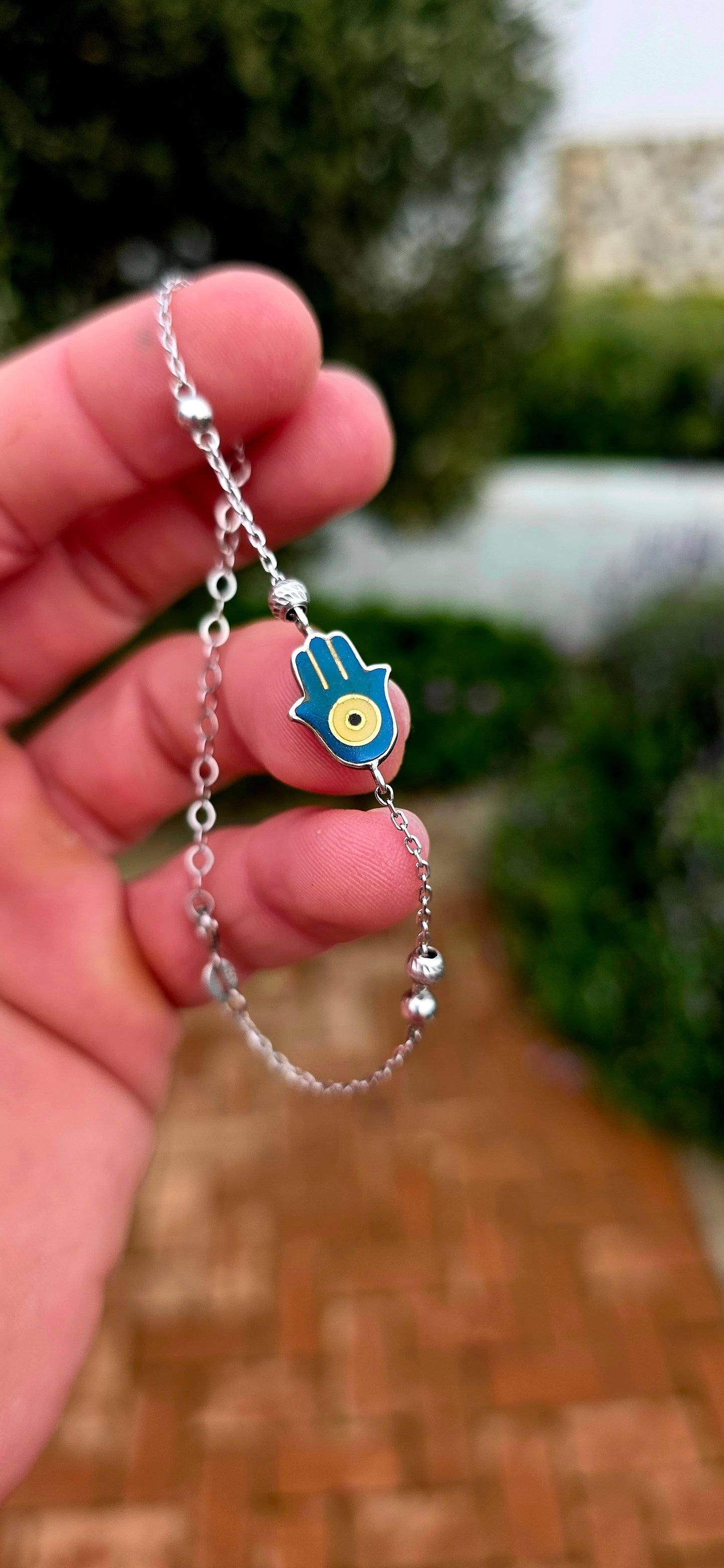 Delicate, meaningful and stylish... this beautiful sterling silver bracelet is centred around one of the world's oldest and most cherished protective symbols — the Hamsa Hand.