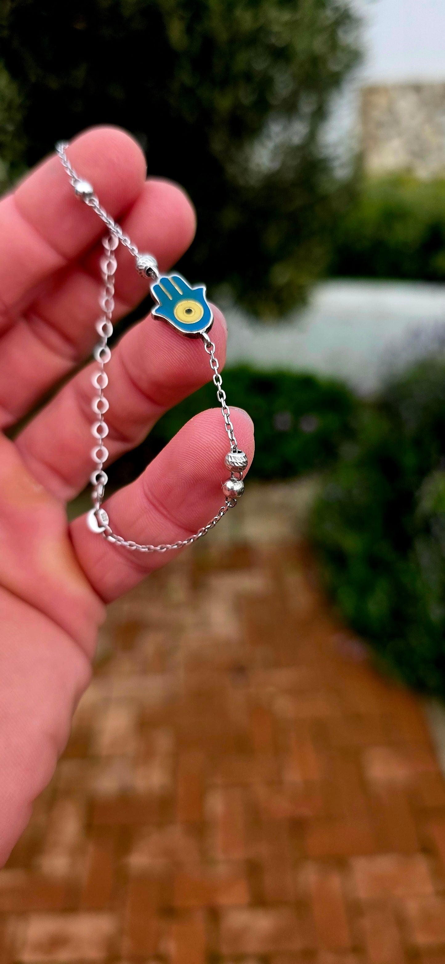 Delicate, meaningful and stylish... this beautiful sterling silver bracelet is centred around one of the world's oldest and most cherished protective symbols — the Hamsa Hand.