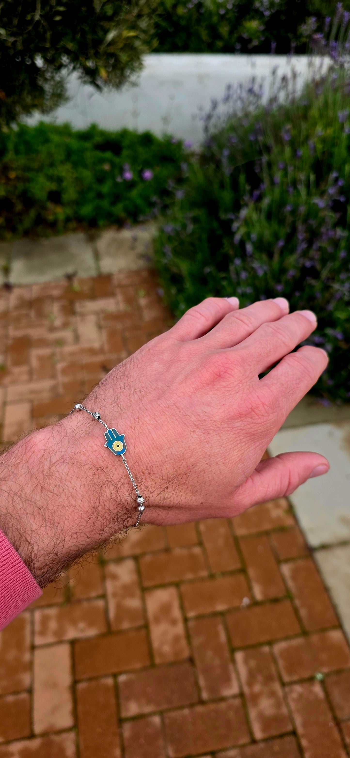 Delicate, meaningful and stylish... this beautiful sterling silver bracelet is centred around one of the world's oldest and most cherished protective symbols — the Hamsa Hand.