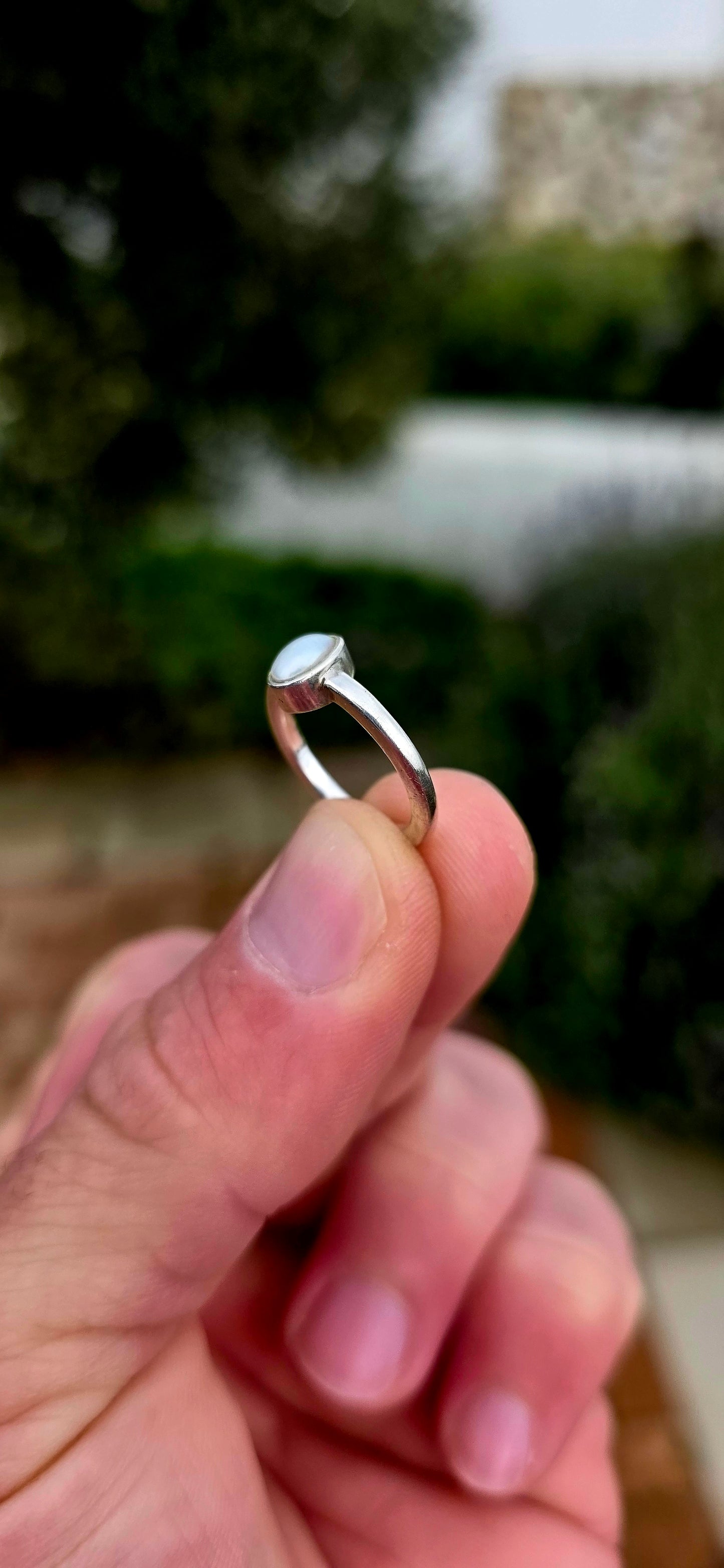 Elegant in its simplicity and timeless in its appeal... this beautifully handmade sterling silver solitaire ring showcases a luminous oval Mabe pearl in the most enchanting soft grey-blue hue.