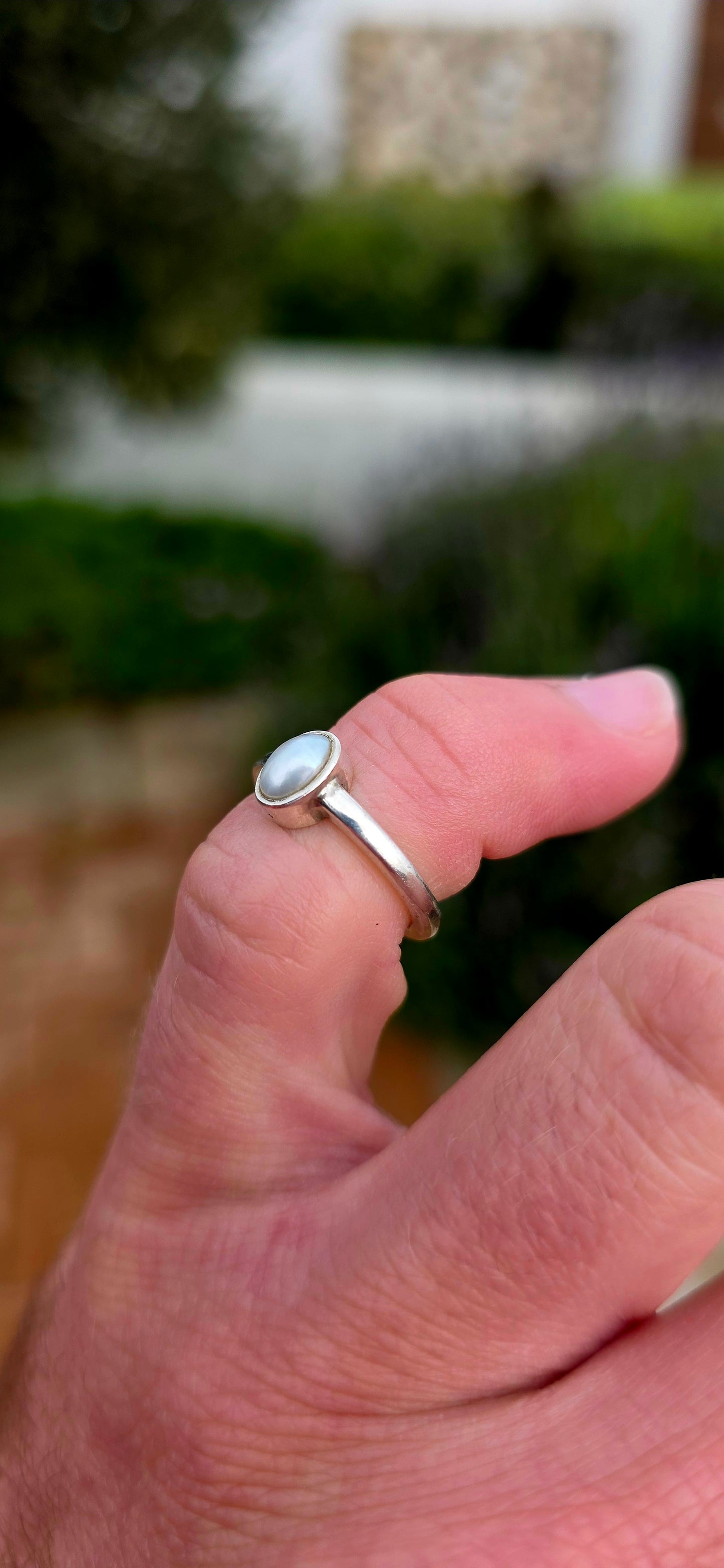 Elegant in its simplicity and timeless in its appeal... this beautifully handmade sterling silver solitaire ring showcases a luminous oval Mabe pearl in the most enchanting soft grey-blue hue.