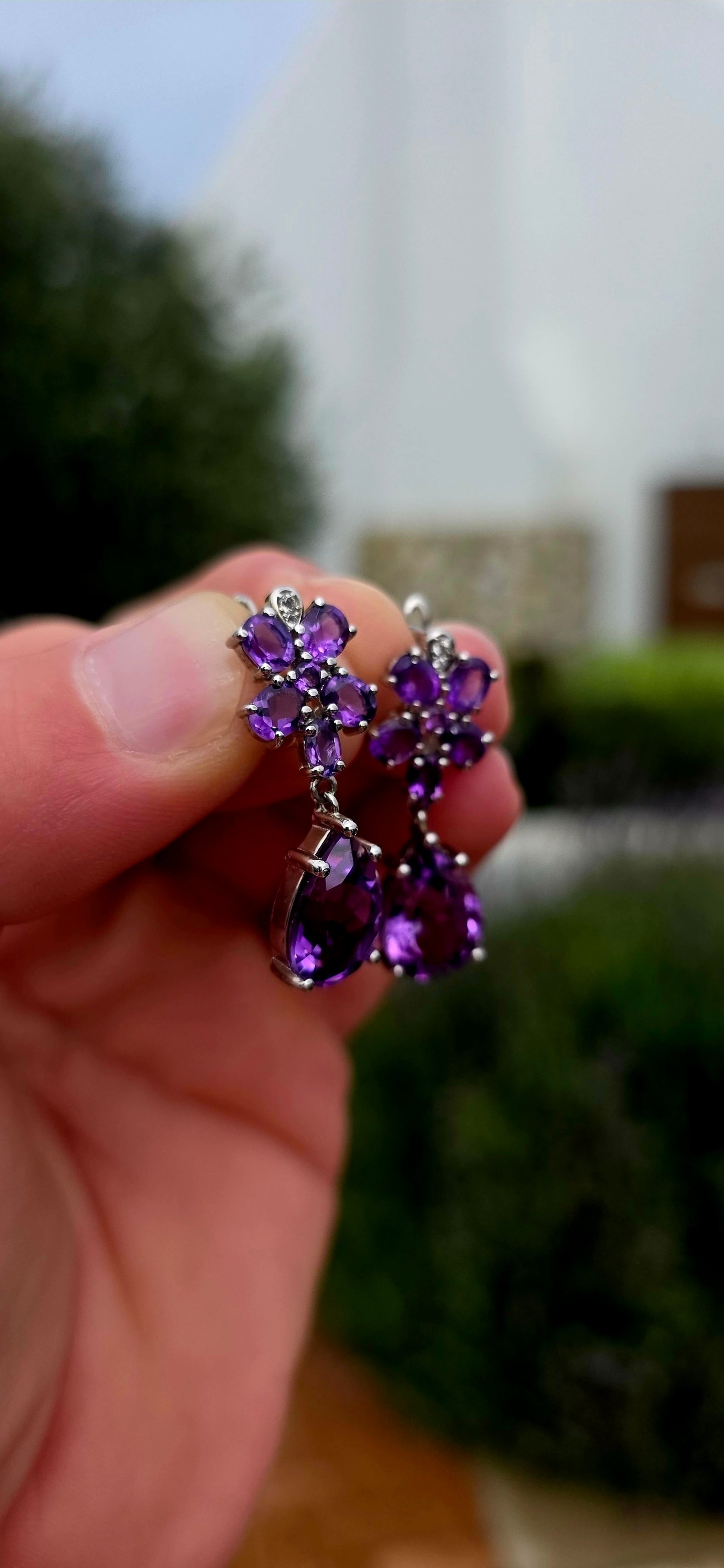 Enchanting, feminine, and absolutely drenched in purple sparkle... these beautiful sterling silver and amethyst drop earrings have the most wonderful floral design, almost resembling a pair of jewelled orchids.