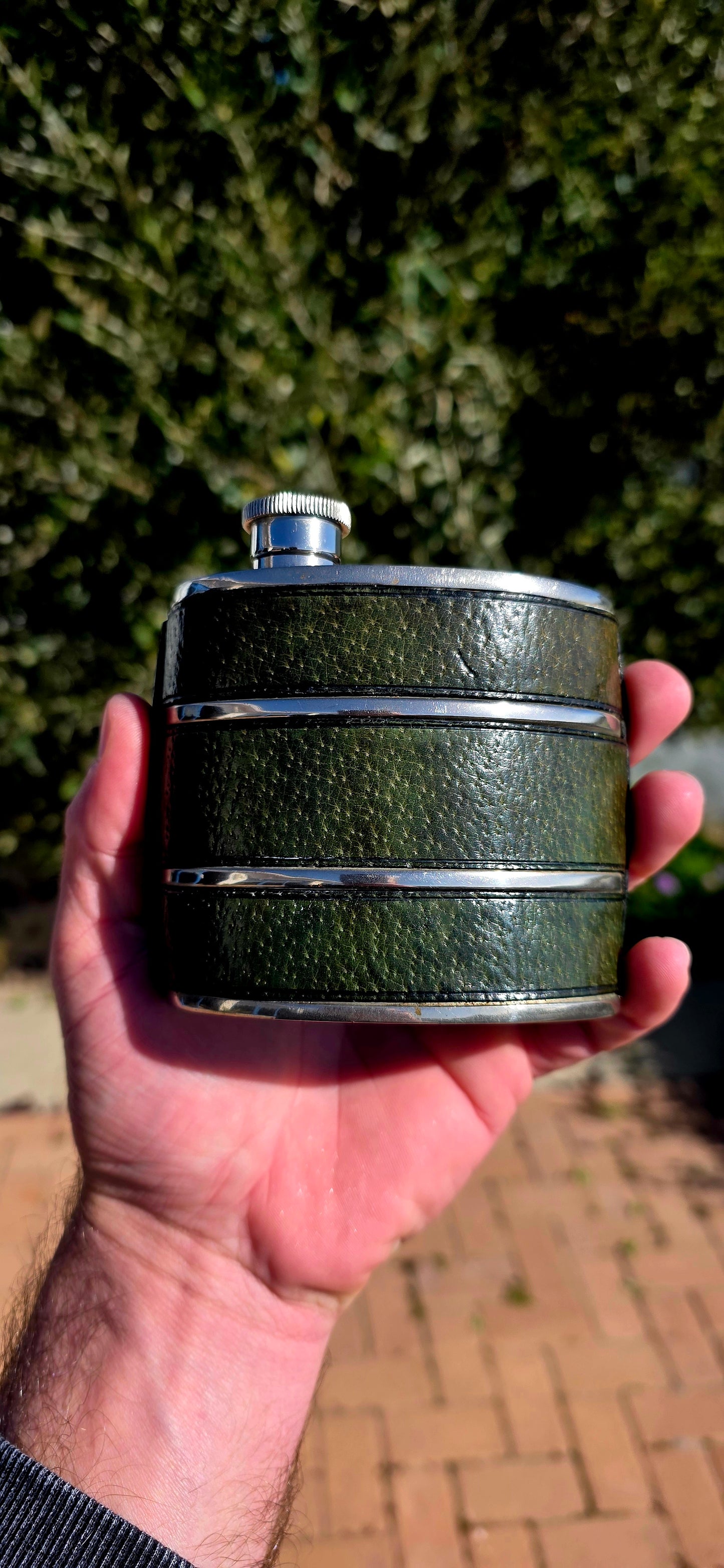 Now THIS is old-school cool.A fabulous vintage 1970s Gucci hip flask, beautifully crafted in metal and wrapped in wonderfully aged deep forest-green leather.