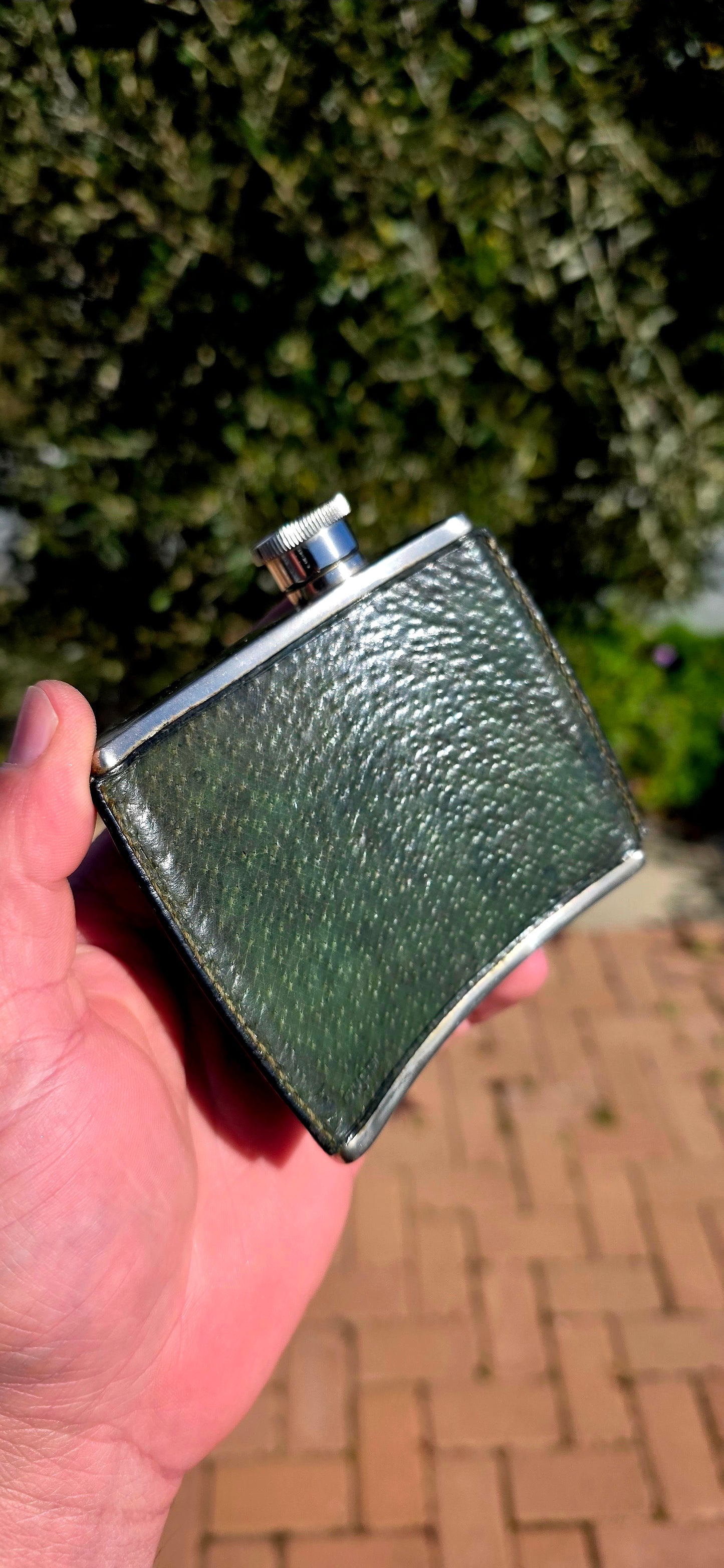 Now THIS is old-school cool.A fabulous vintage 1970s Gucci hip flask, beautifully crafted in metal and wrapped in wonderfully aged deep forest-green leather.