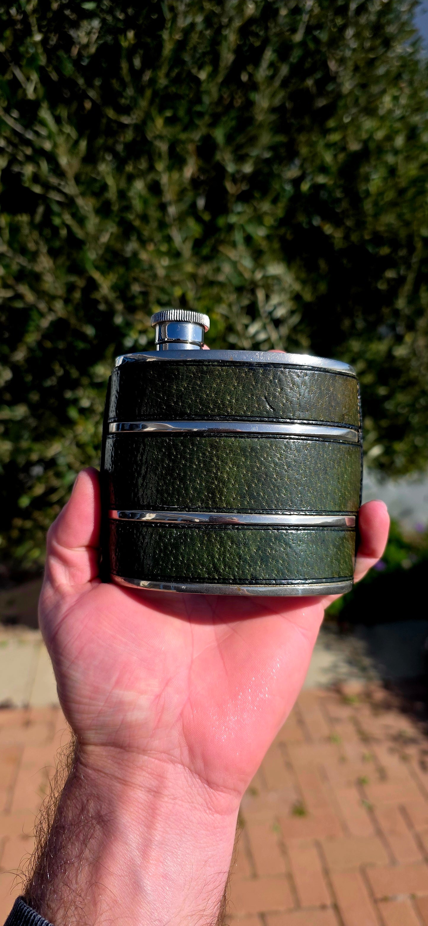 Now THIS is old-school cool.A fabulous vintage 1970s Gucci hip flask, beautifully crafted in metal and wrapped in wonderfully aged deep forest-green leather.