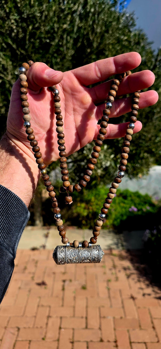 A beautiful Tibetan/Himalayan Buddhist mala-style necklace centred by an ornate sterling silver Ga'u (Ghau) prayer-box amulet.