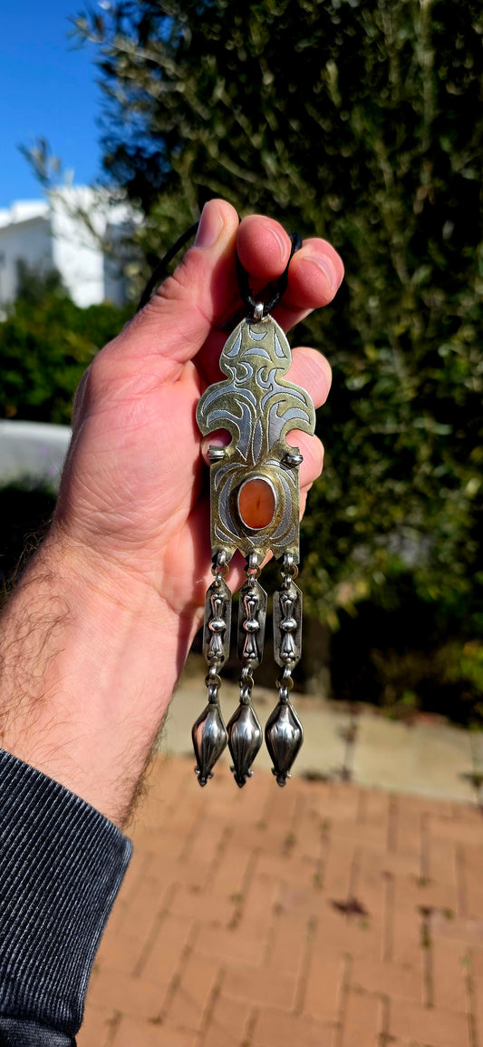 This antique Turkoman pendant is beautifully crafted in sterling silver, with contrasting gold-plated accents highlighting the bold engraved decoration.