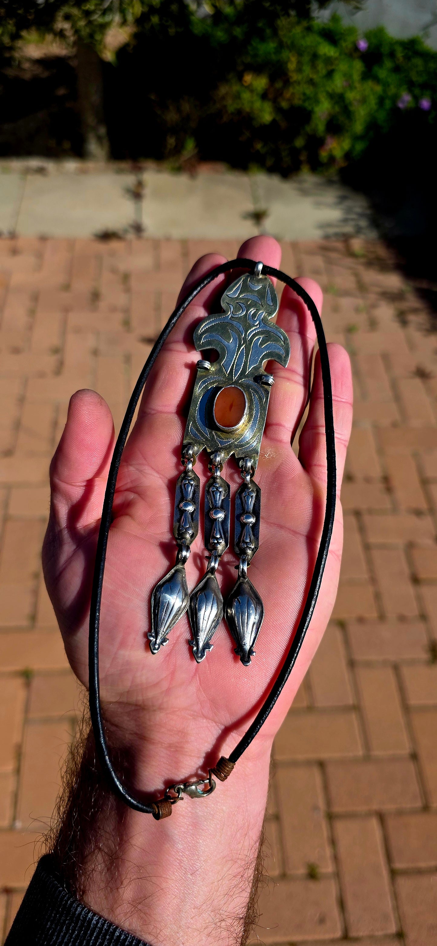 This antique Turkoman pendant is beautifully crafted in sterling silver, with contrasting gold-plated accents highlighting the bold engraved decoration.