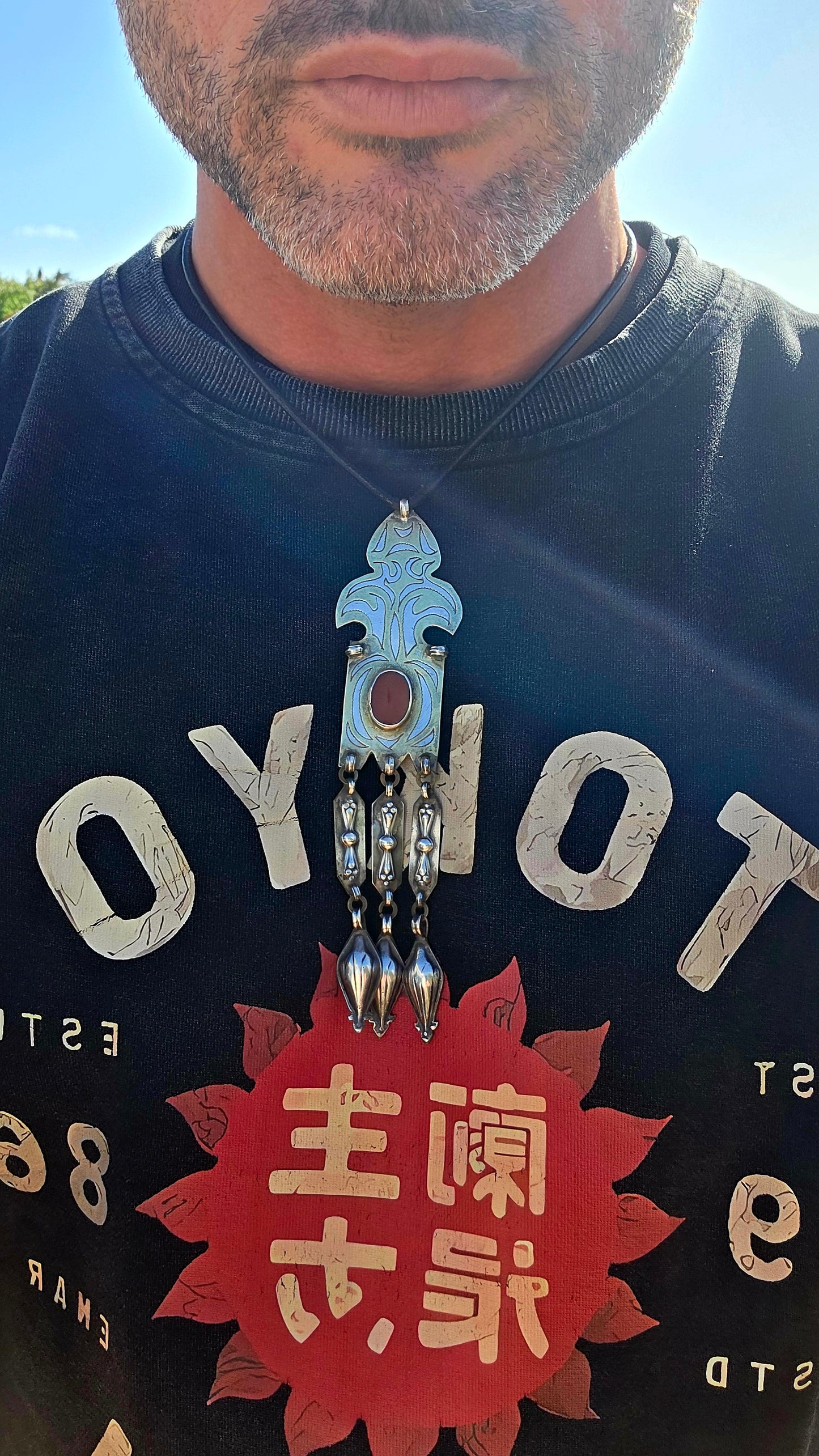 This antique Turkoman pendant is beautifully crafted in sterling silver, with contrasting gold-plated accents highlighting the bold engraved decoration.