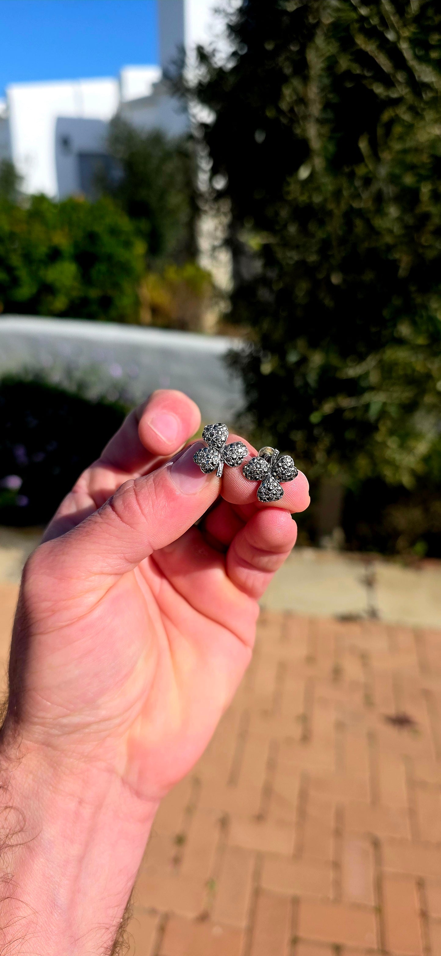 A wonderfully charming pair of Art Deco-era sterling silver screw-back earrings, each fashioned as a beautifully dimensional three-leaf clover and glittering with tiny marcasites.