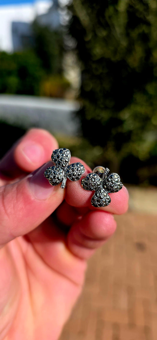 A wonderfully charming pair of Art Deco-era sterling silver screw-back earrings, each fashioned as a beautifully dimensional three-leaf clover and glittering with tiny marcasites.
