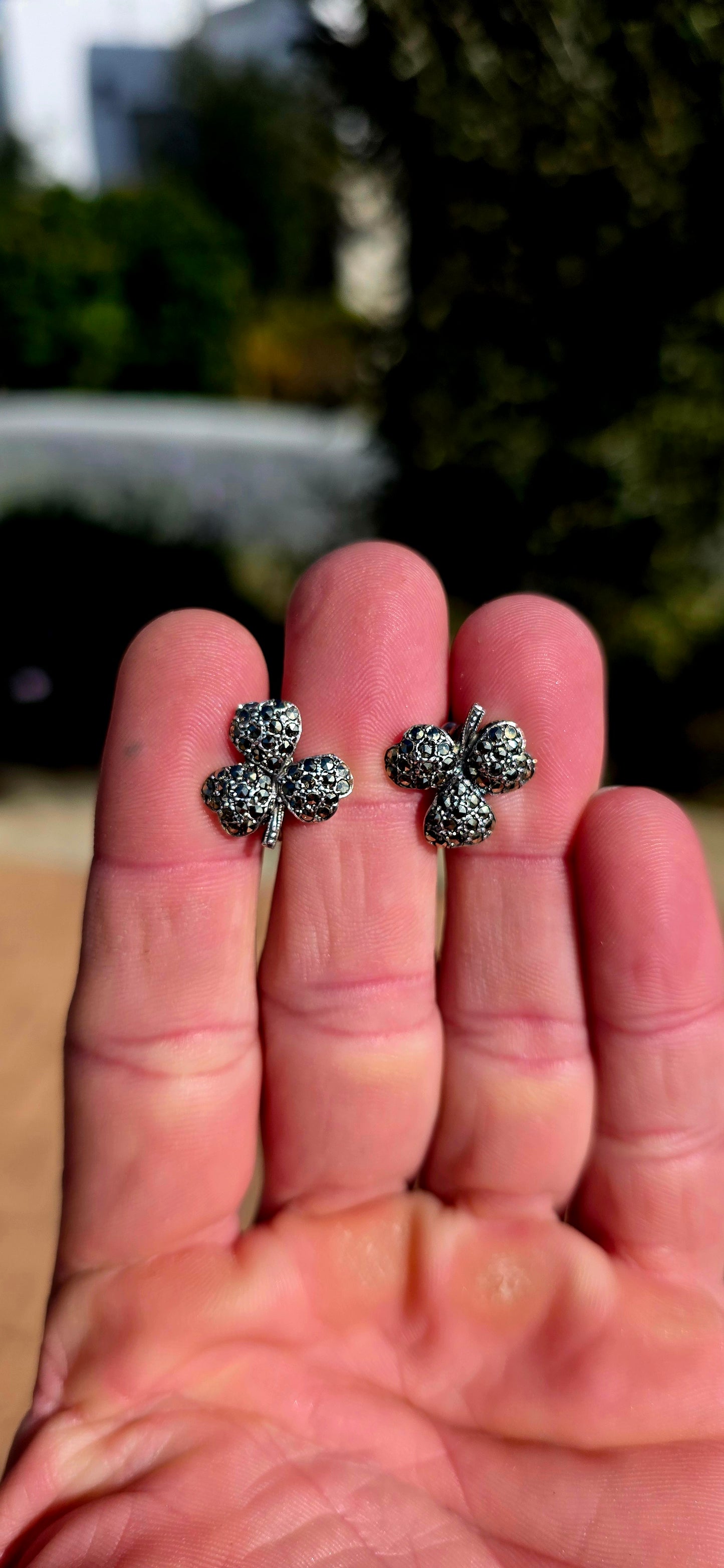 A wonderfully charming pair of Art Deco-era sterling silver screw-back earrings, each fashioned as a beautifully dimensional three-leaf clover and glittering with tiny marcasites.