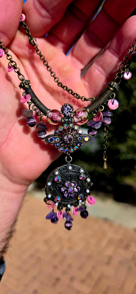 A beautifully handmade statement costume necklace, crafted in antique-bronze-tone metal and dripping with gorgeous shades of amethyst, violet, lavender and pink.