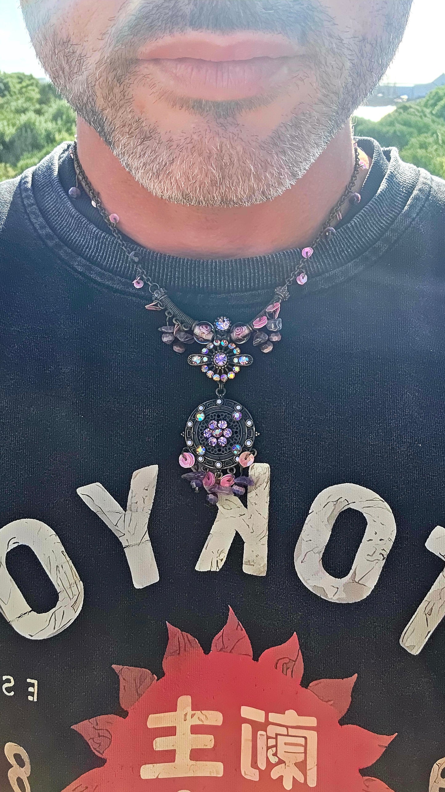 A beautifully handmade statement costume necklace, crafted in antique-bronze-tone metal and dripping with gorgeous shades of amethyst, violet, lavender and pink.