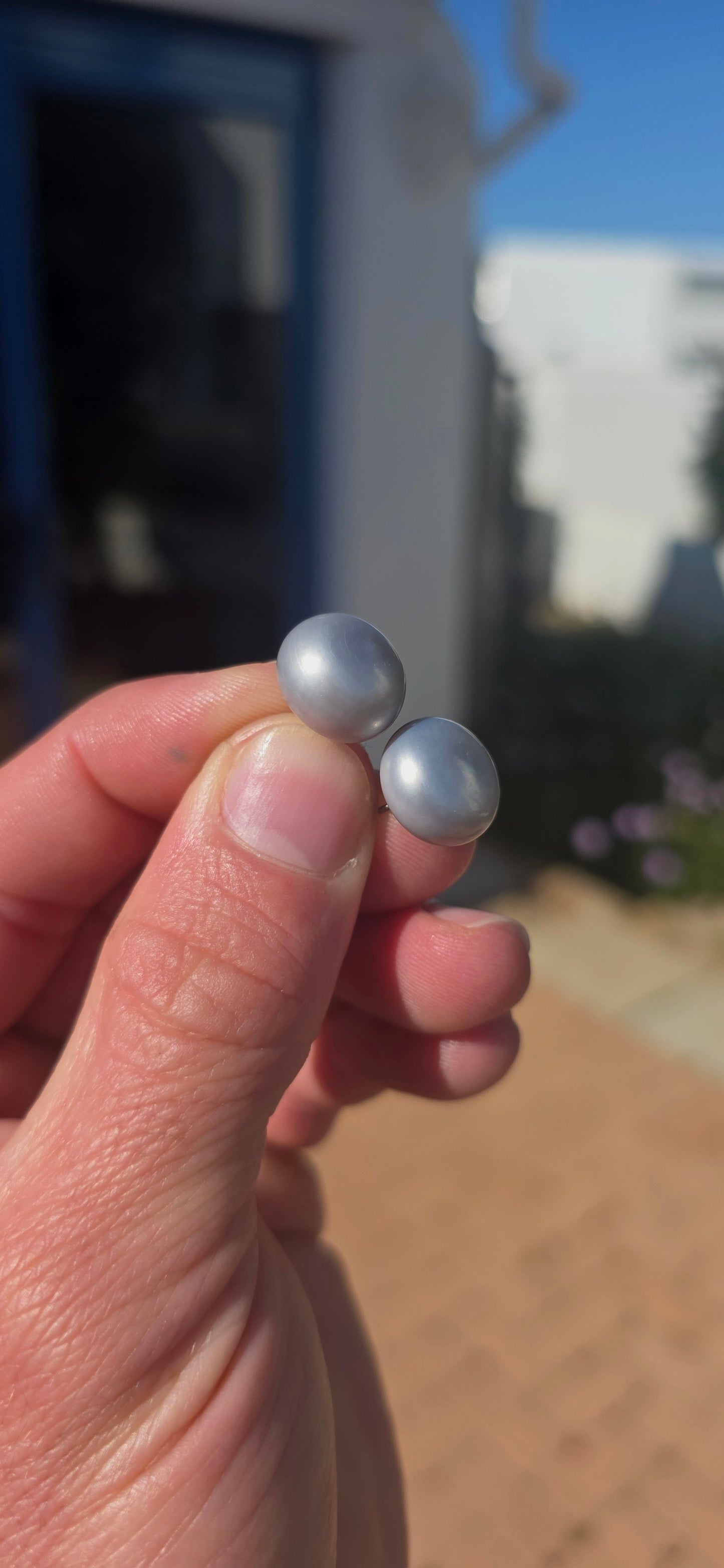 Beautifully classic with a wonderfully modern edge… this generously sized pair of freshwater button pearl stud earrings features gorgeous smoky silvery-grey pearls with a soft natural lustre and subtle flashes of blue-grey as they catch the light.