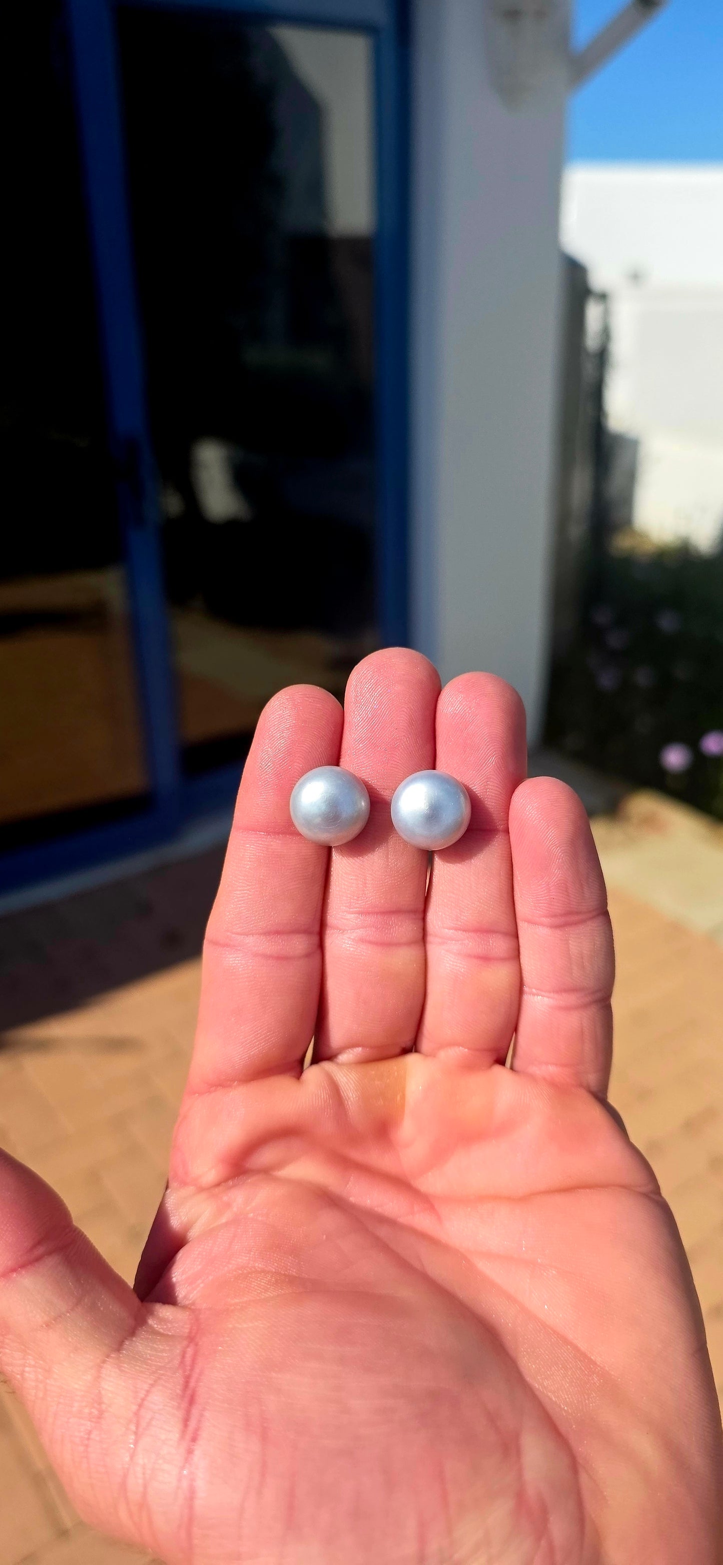 Beautifully classic with a wonderfully modern edge… this generously sized pair of freshwater button pearl stud earrings features gorgeous smoky silvery-grey pearls with a soft natural lustre and subtle flashes of blue-grey as they catch the light.