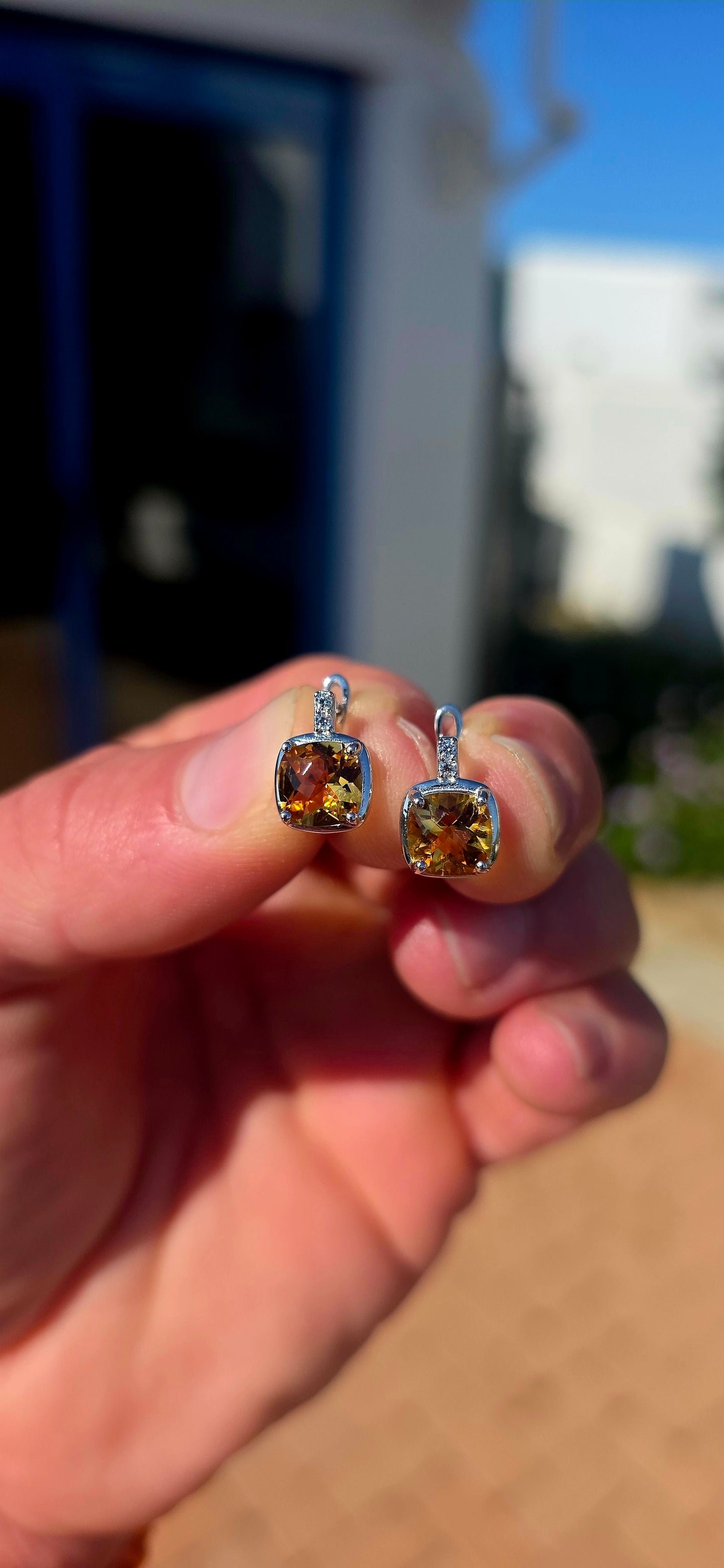 Elegant, classic and filled with the most gorgeous warm colour! These beautiful sterling silver drop earrings each feature a generously sized cushion-cut citrine gemstone, glowing in rich golden honey and champagne tones.