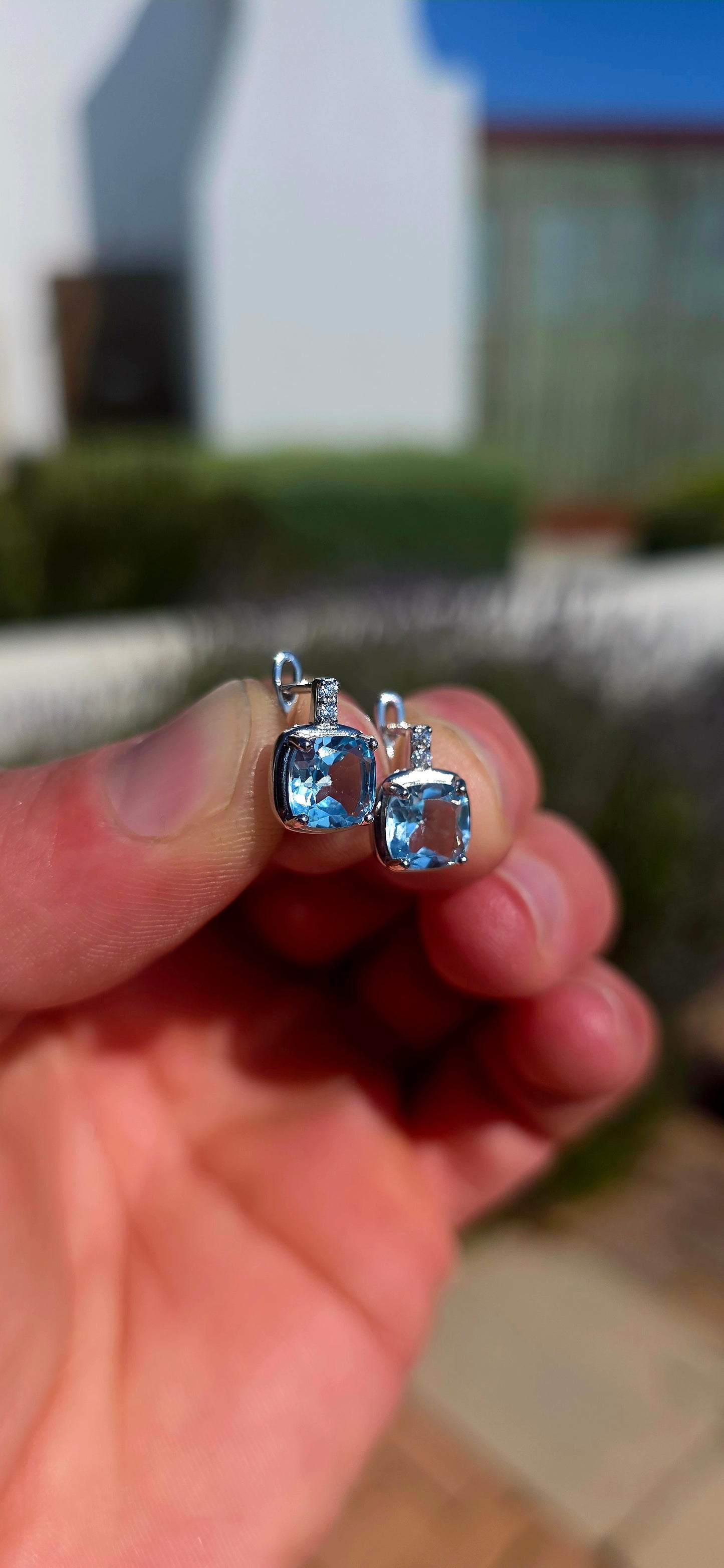 Fresh, elegant and SO beautifully sparkly! These gorgeous sterling silver drop earrings each feature a generously sized cushion-cut sky blue topaz, glowing in the prettiest crystal-clear icy blue.
