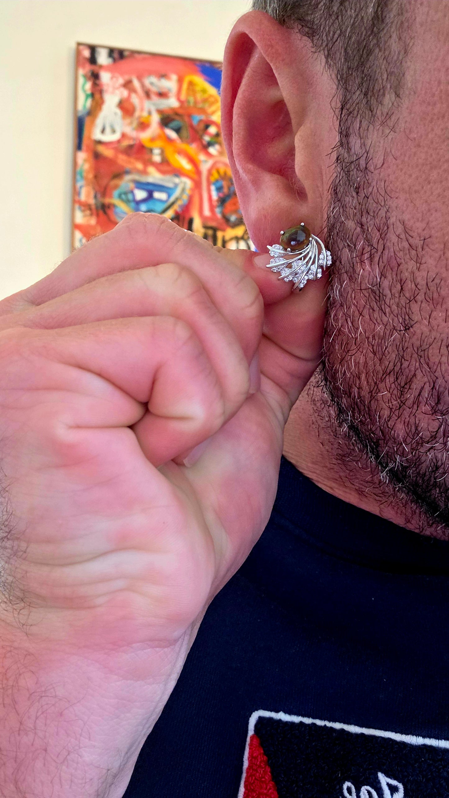 These enchanting sterling silver earrings each feature an oval dark-bodied Ethiopian opal cabochon, displaying those magical flashes of green, orange, gold and blue as they move through the light.