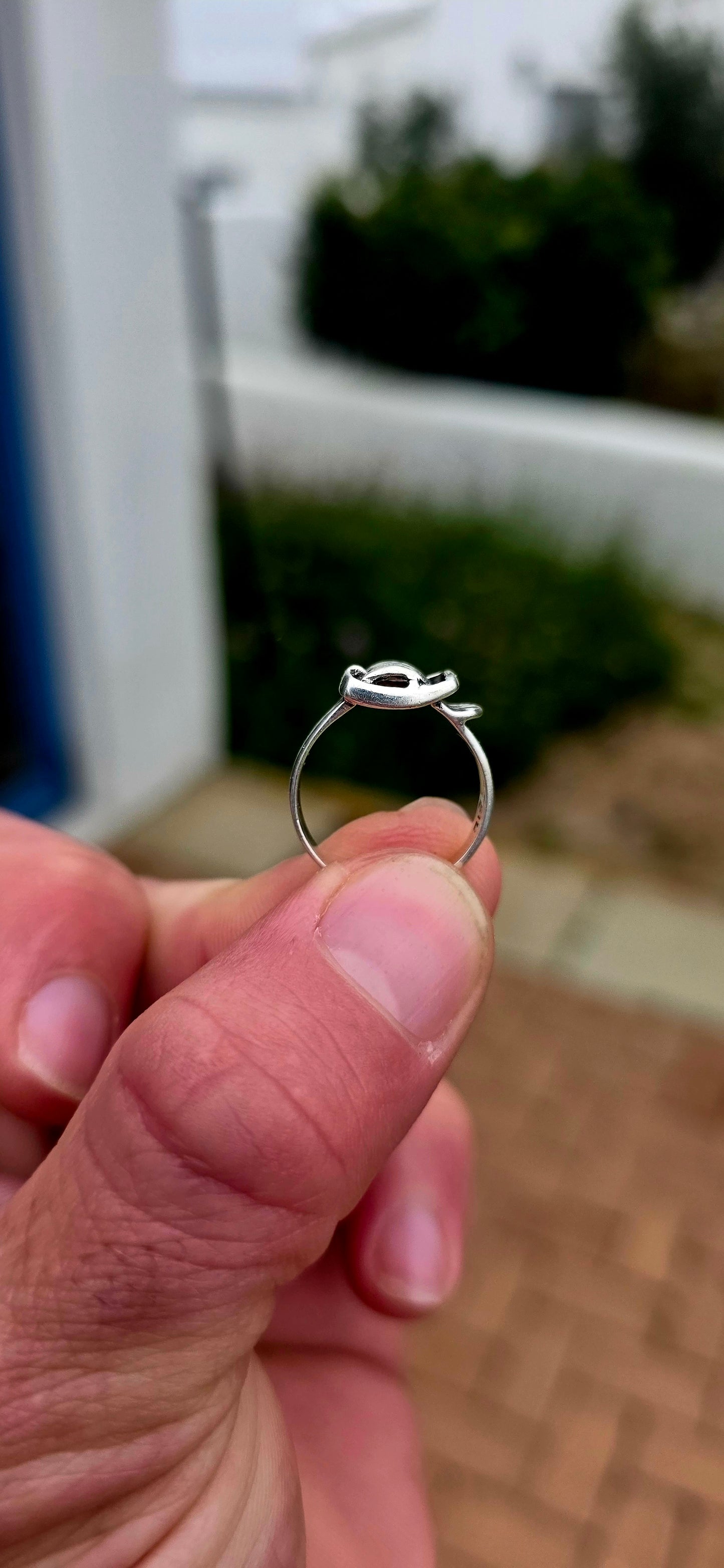 A vintage sterling silver Victorian Revival pinky ring, fashioned in the form of a miniature belt and buckle, complete with wonderful textured detailing and a raised buckle across the front.