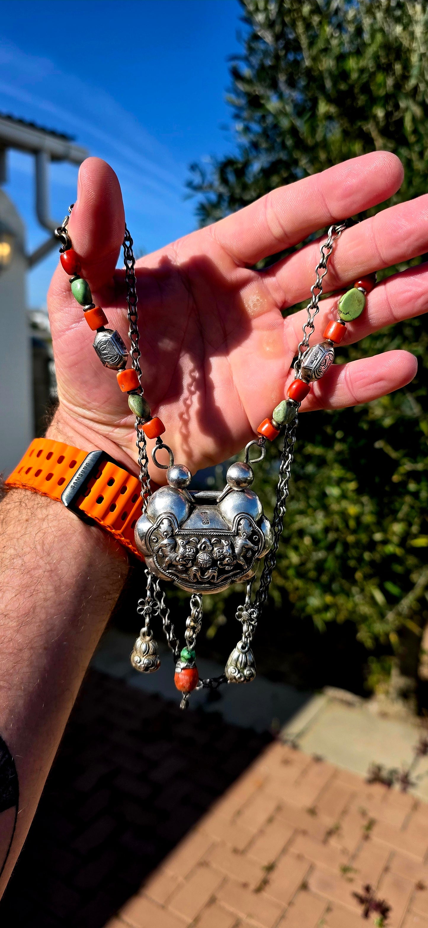 An absolutely extraordinary antique Chinese Qing Dynasty / early 20th-century sterling silver “Longevity Lock” necklace, richly decorated with traditional auspicious imagery and strung with vibrant coral and turquoise gemstone beads.