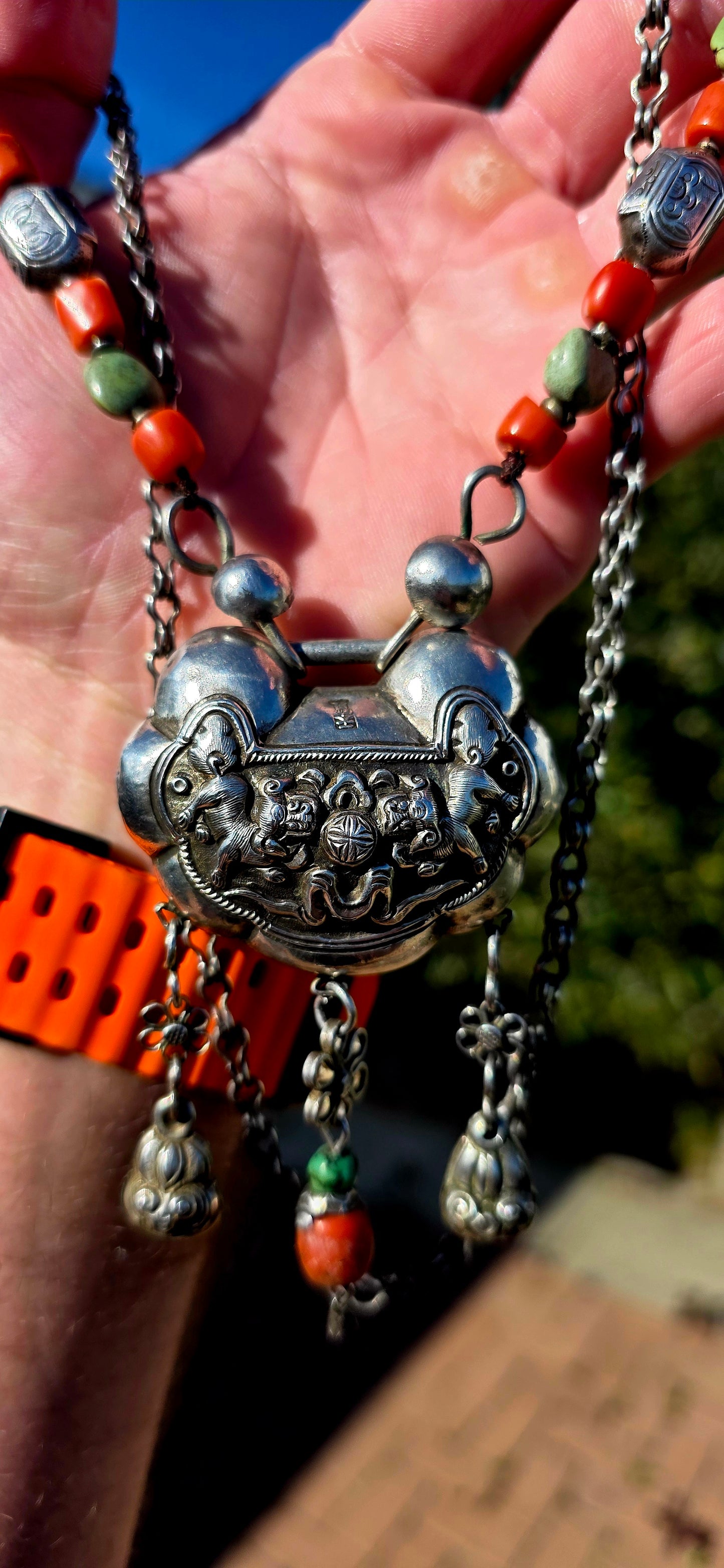 An absolutely extraordinary antique Chinese Qing Dynasty / early 20th-century sterling silver “Longevity Lock” necklace, richly decorated with traditional auspicious imagery and strung with vibrant coral and turquoise gemstone beads.