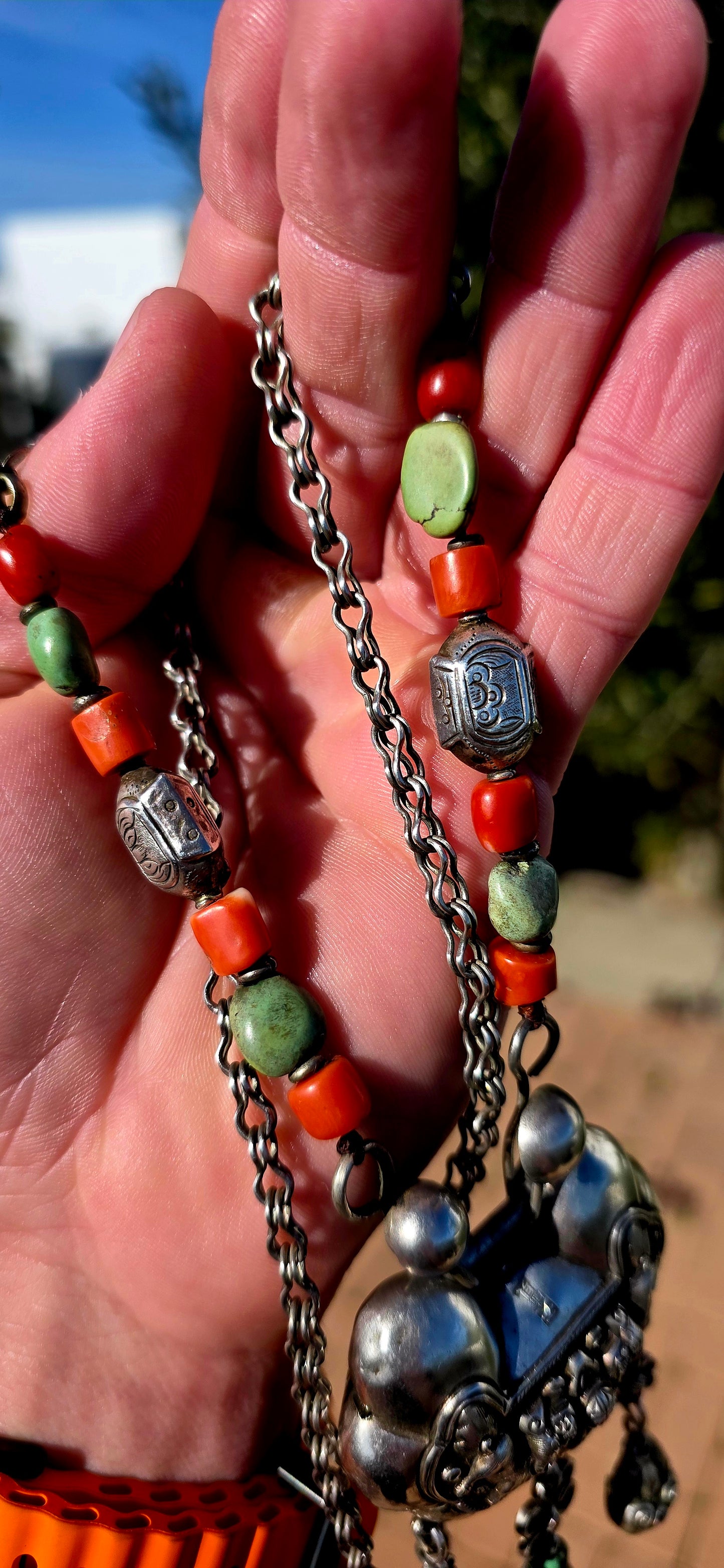An absolutely extraordinary antique Chinese Qing Dynasty / early 20th-century sterling silver “Longevity Lock” necklace, richly decorated with traditional auspicious imagery and strung with vibrant coral and turquoise gemstone beads.