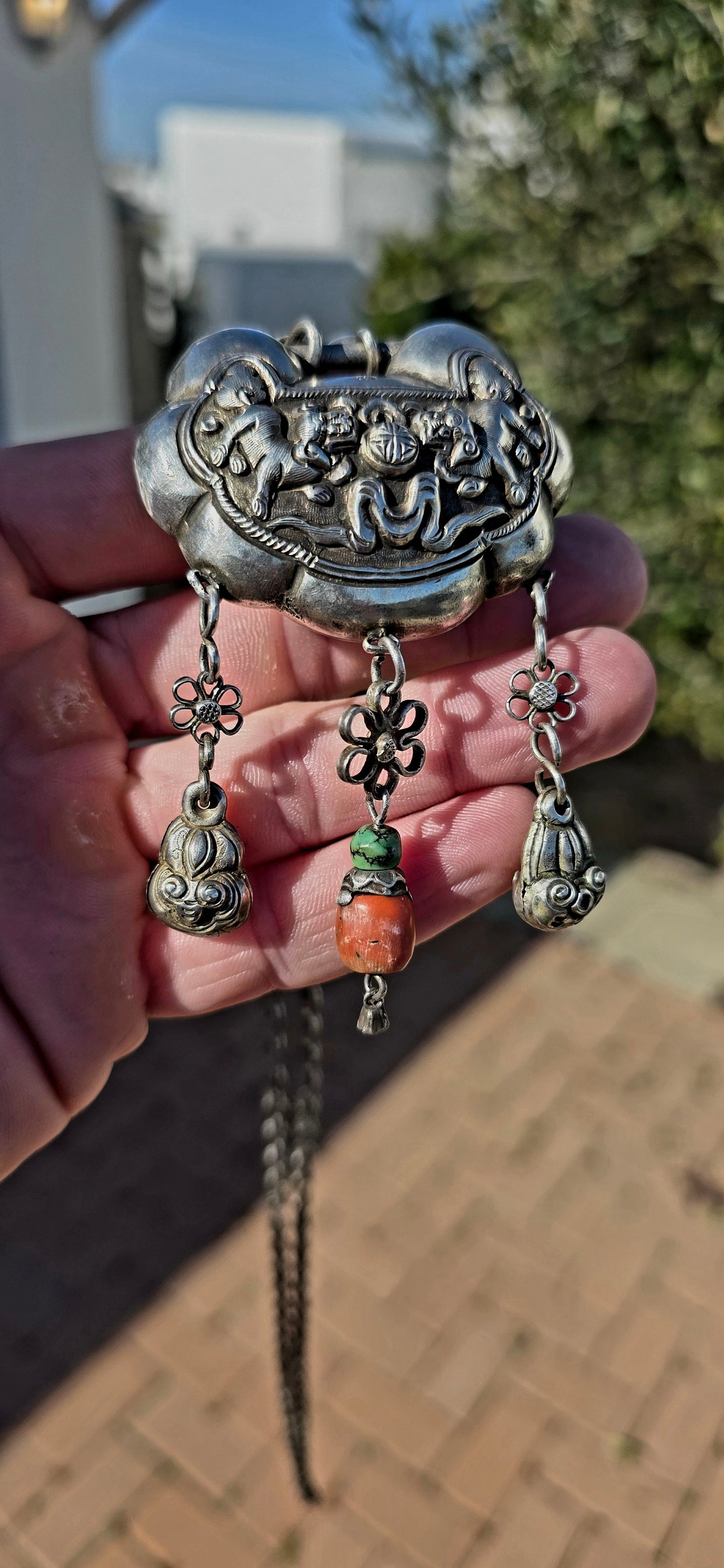 An absolutely extraordinary antique Chinese Qing Dynasty / early 20th-century sterling silver “Longevity Lock” necklace, richly decorated with traditional auspicious imagery and strung with vibrant coral and turquoise gemstone beads.