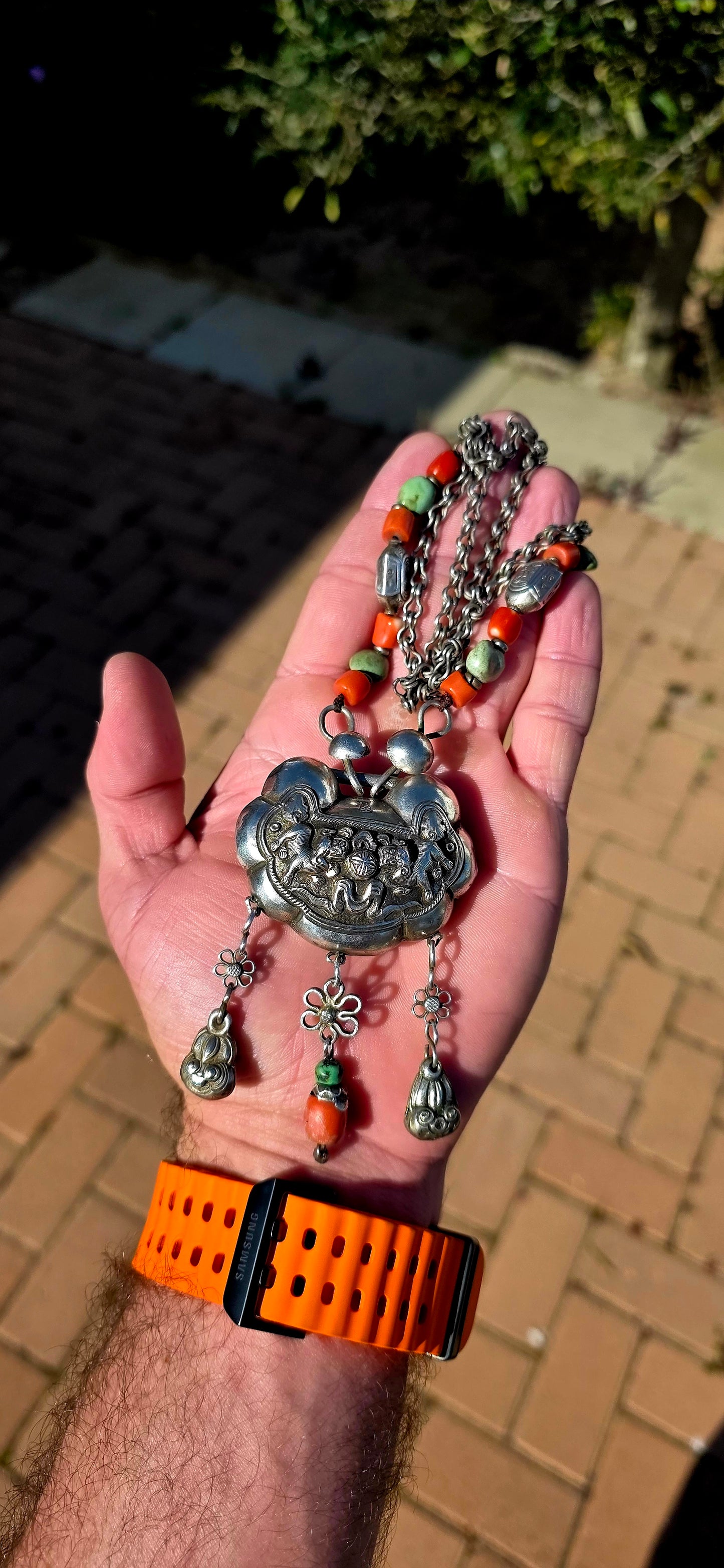 An absolutely extraordinary antique Chinese Qing Dynasty / early 20th-century sterling silver “Longevity Lock” necklace, richly decorated with traditional auspicious imagery and strung with vibrant coral and turquoise gemstone beads.