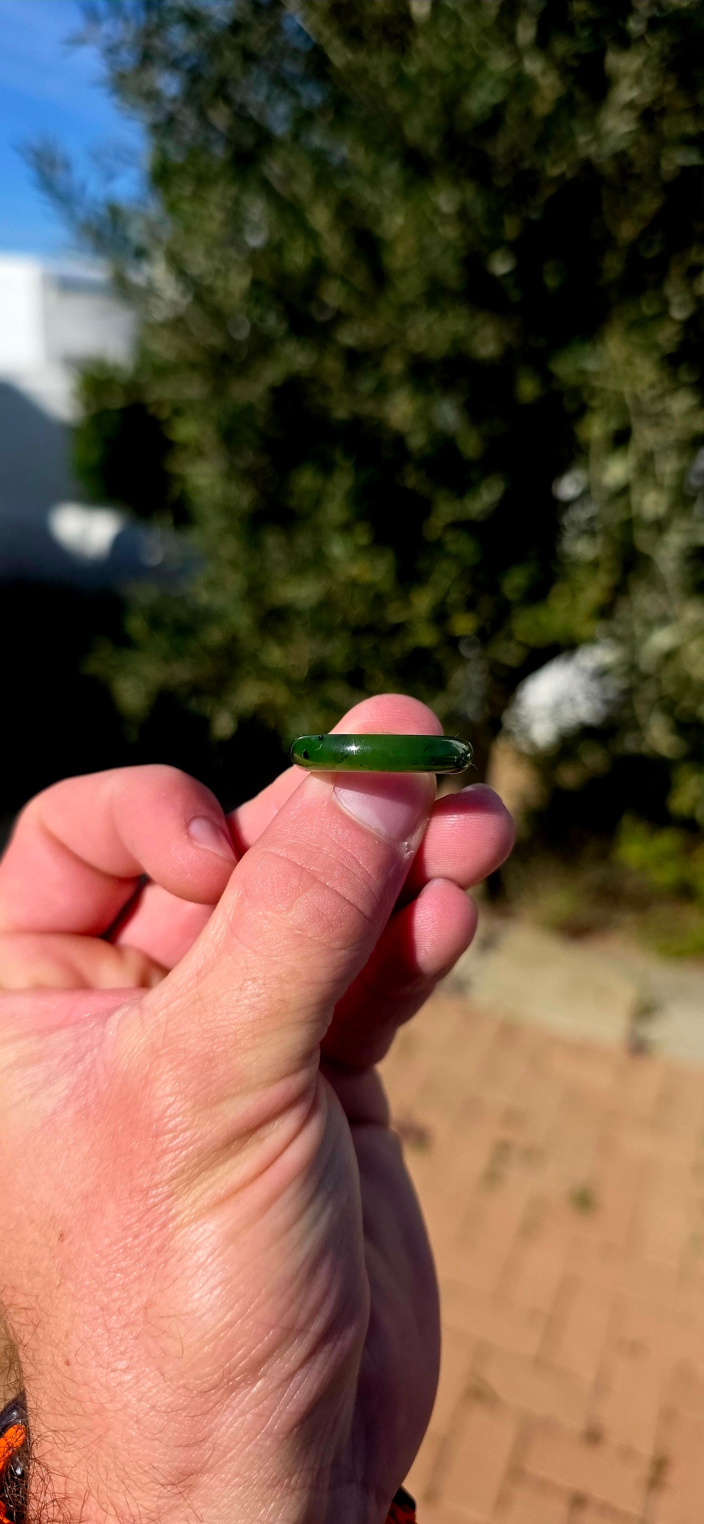 Simple, earthy and beautifully tactile, this solid nephrite jade ring has been carved entirely from a single piece of jade, creating a wonderfully smooth continuous band with no metal setting or embellishment to distract from the jade itself.