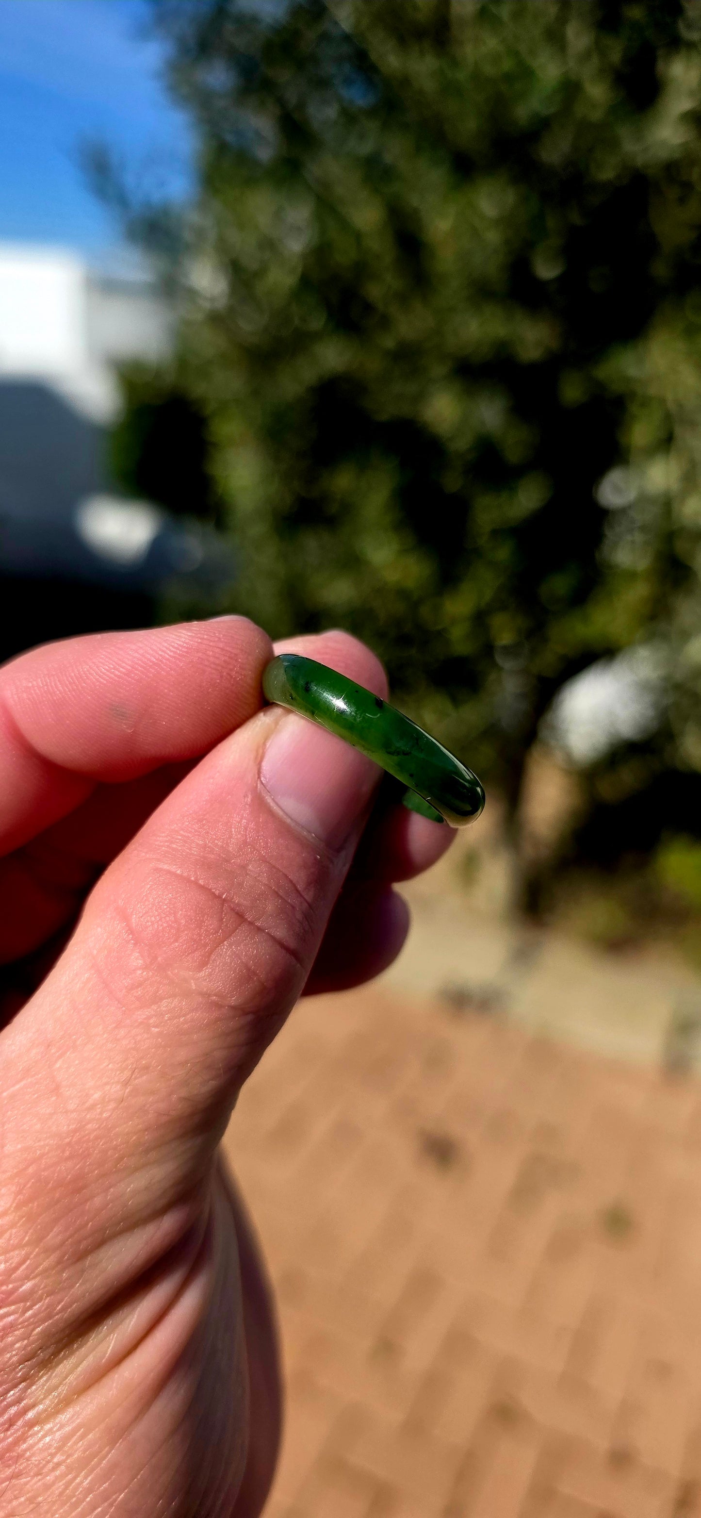 Simple, earthy and beautifully tactile, this solid nephrite jade ring has been carved entirely from a single piece of jade, creating a wonderfully smooth continuous band with no metal setting or embellishment to distract from the jade itself.