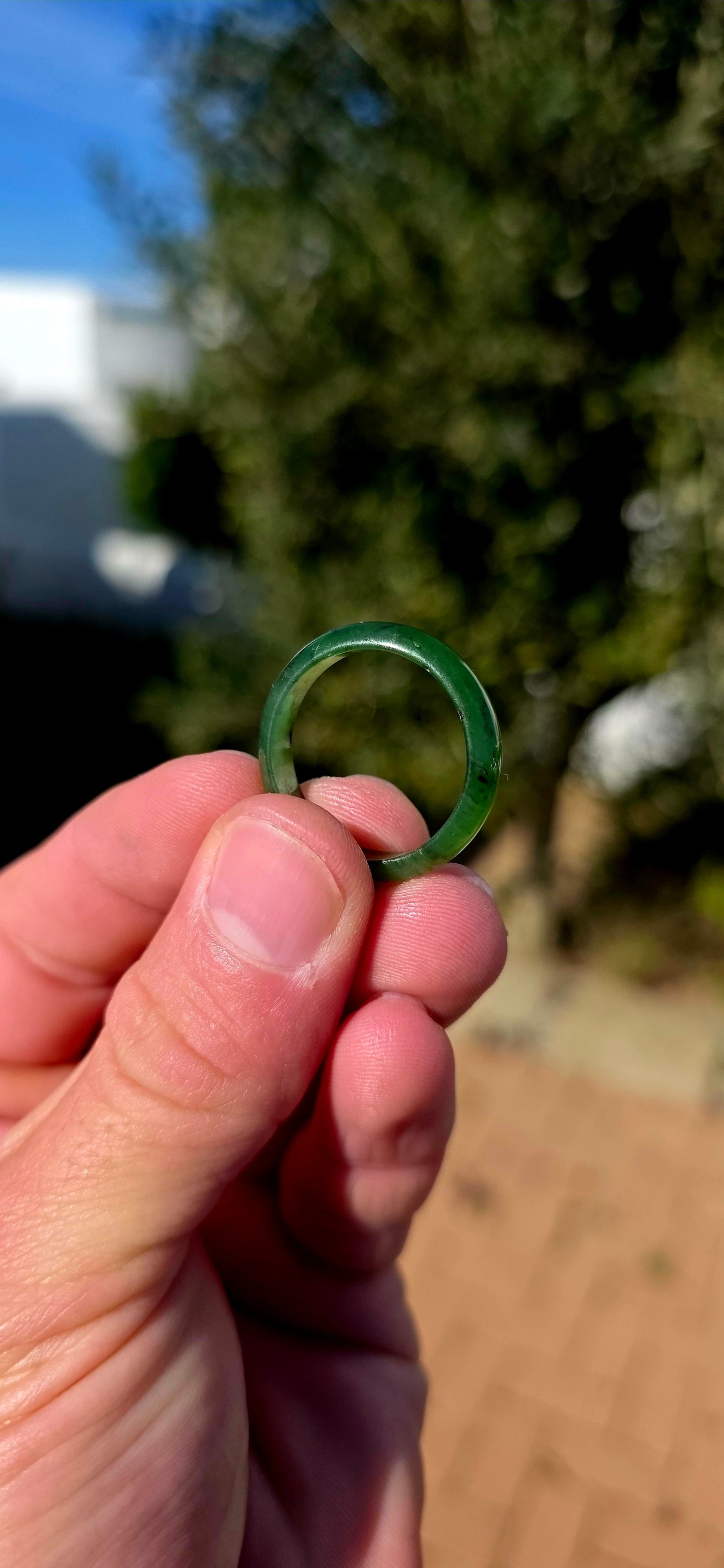 Simple, earthy and beautifully tactile, this solid nephrite jade ring has been carved entirely from a single piece of jade, creating a wonderfully smooth continuous band with no metal setting or embellishment to distract from the jade itself.