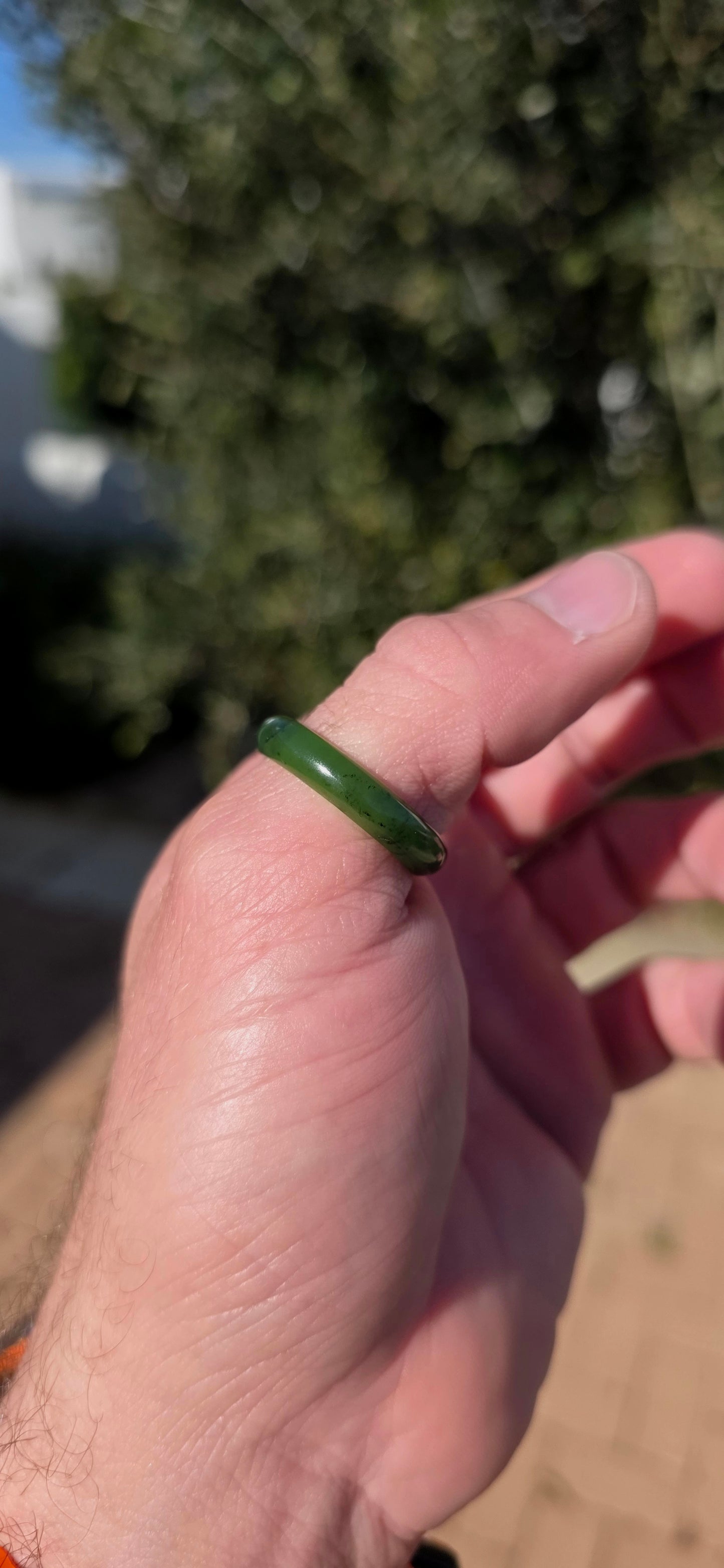 Simple, earthy and beautifully tactile, this solid nephrite jade ring has been carved entirely from a single piece of jade, creating a wonderfully smooth continuous band with no metal setting or embellishment to distract from the jade itself.