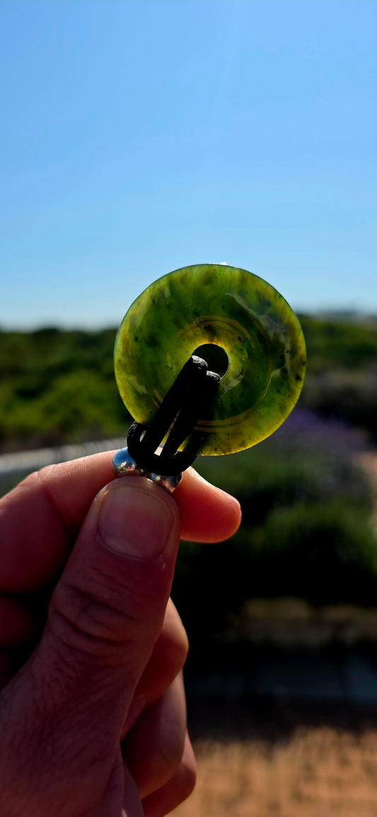Earthy, tribal and cool! A fabulous vintage unisex necklace centred around a generously sized polished deep forest-green nephrite jade disc pendant, with its simple circular form giving the piece a wonderfully organic, almost talismanic feel.