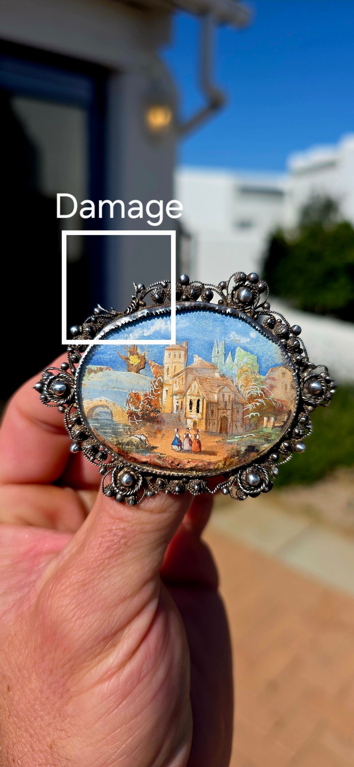 A truly beautiful and oversized antique Victorian-era sterling silver brooch, centred with a wonderfully detailed hand-painted miniature landscape scene, preserved beneath its original domed glass.